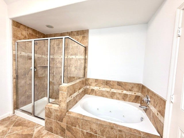 6363 Fairdale Lane, #L, Houston, TX 77057 Primary bath features a large glass-enclosed walk-in shower with bench seat and an oversize JETTED SPA tub!