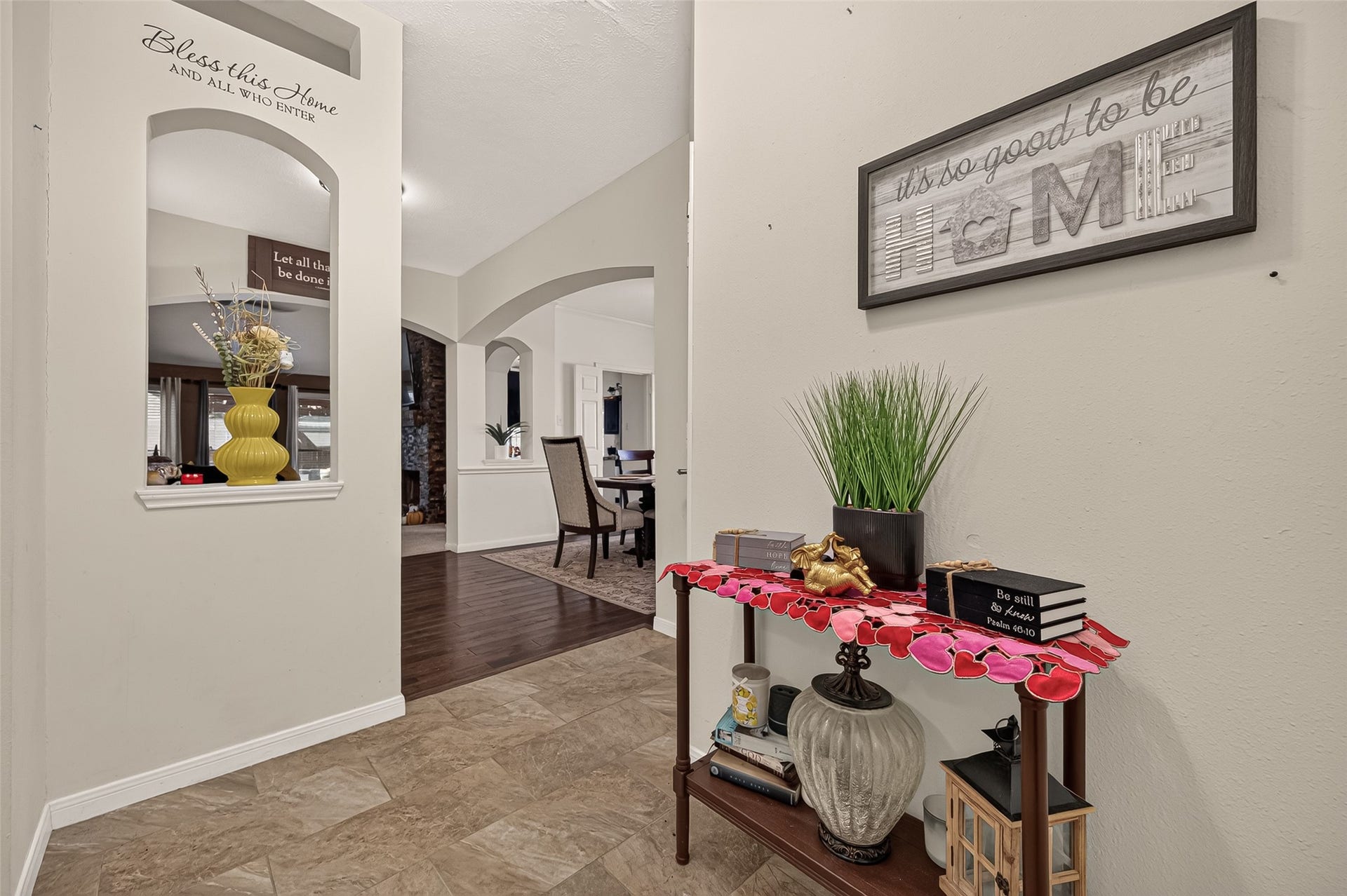 1615 Glacier Blue Drive, Fresno, TX 77545 Charming entryway with stylish decor and inviting archways leads into a spacious dining area, featuring elegant flooring and warm, welcoming accents.
