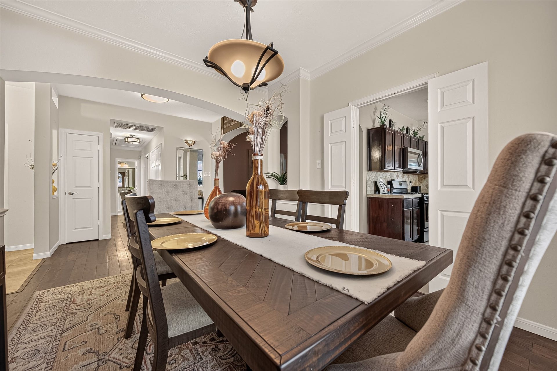 1615 Glacier Blue Drive, Fresno, TX 77545 Elegant dining room featuring stylish lighting, and easy access to a modern kitchen, perfect for entertaining.