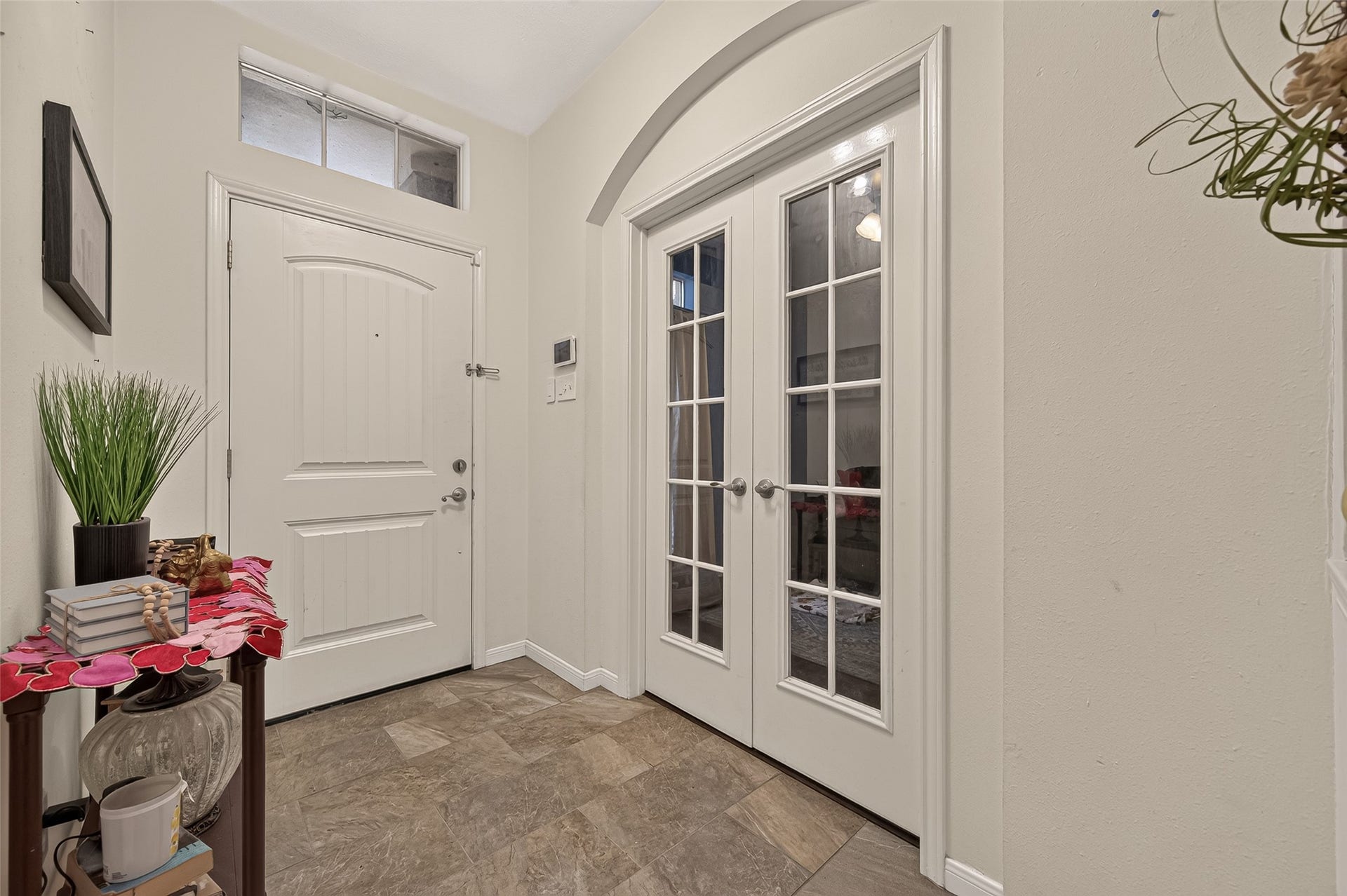 1615 Glacier Blue Drive, Fresno, TX 77545 Elegant entryway featuring double French doors, abundant natural light, and stylish tile flooring, creating a welcoming first impression.