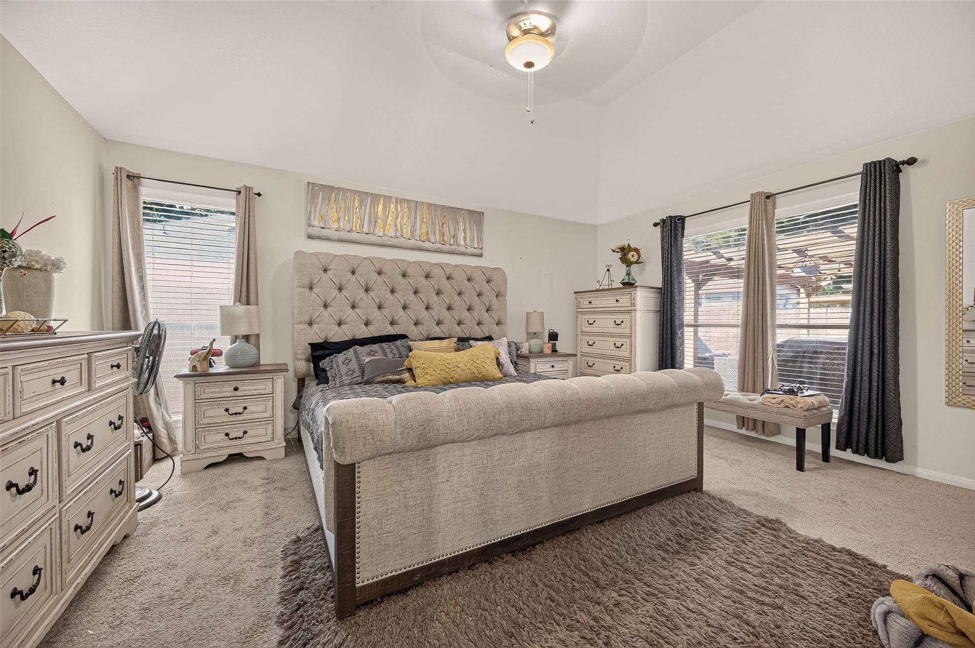 1615 Glacier Blue Drive, Fresno, TX 77545 Spacious bedroom with a plush tufted bed, neutral tones, and ample natural light from large windows.