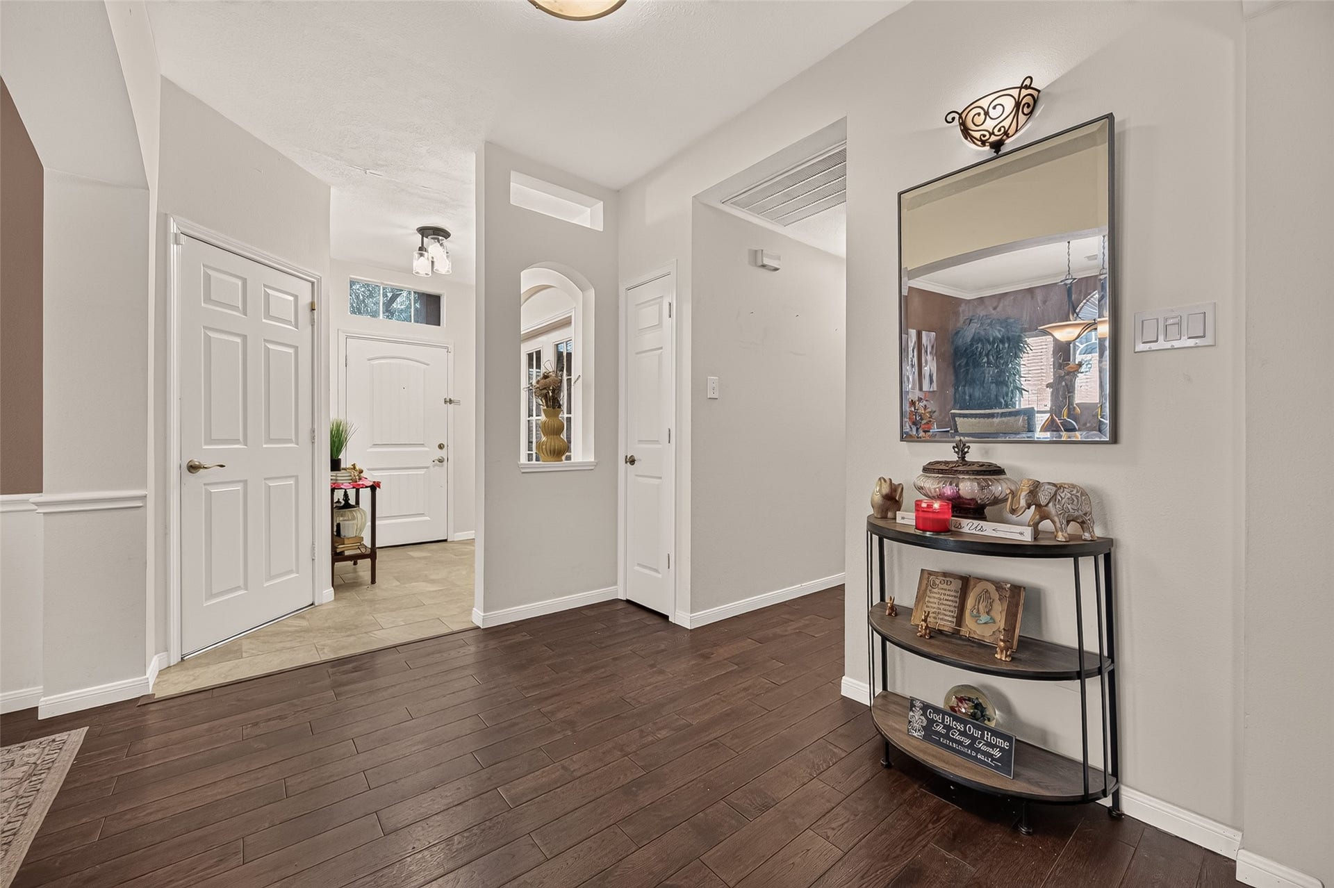 1615 Glacier Blue Drive, Fresno, TX 77545 Inviting entryway with elegant dark egineered laminate flooring, fresh neutral walls, and stylish lighting, creating a warm and welcoming atmosphere.