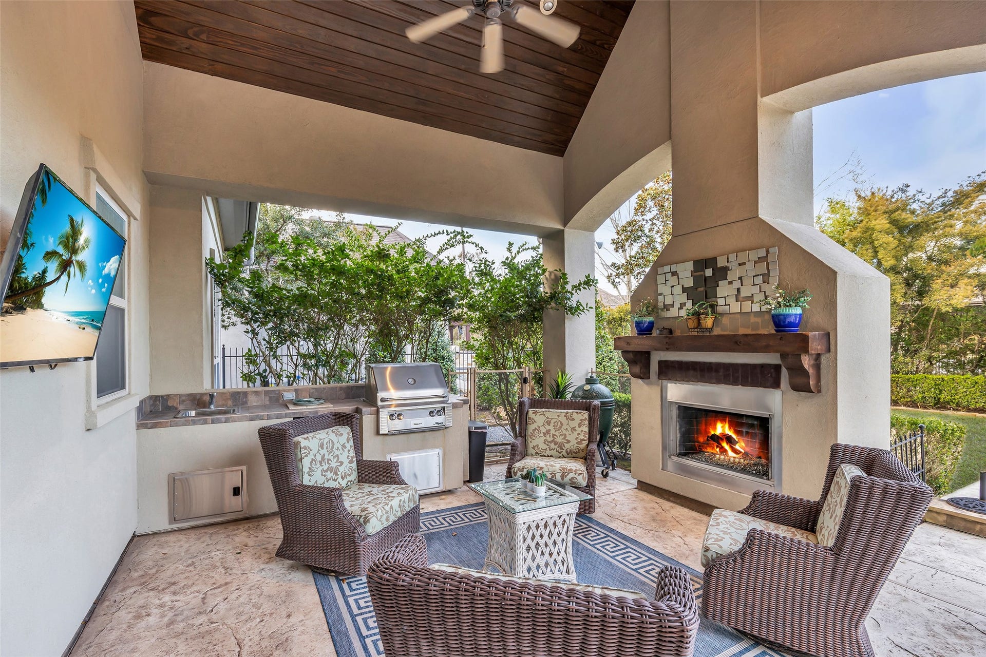75 S Player Crest Circle, The Woodlands, TX 77382 Back Covered Patio with Fireplace and Outdoor Kitchen
