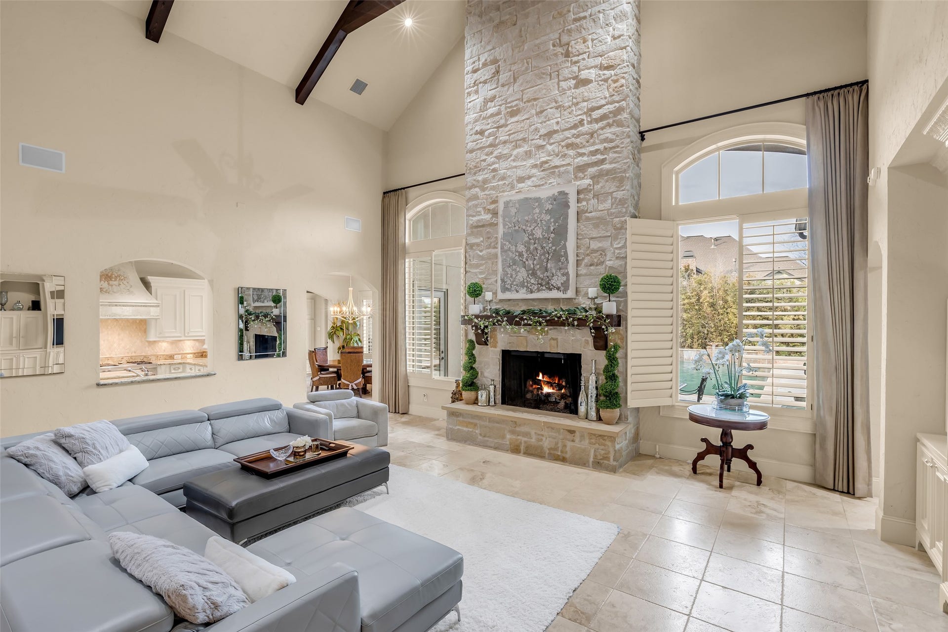75 S Player Crest Circle, The Woodlands, TX 77382 2 Story Family Room with Floor to Ceiling Stone Fireplace Overlooking the Sparkling Pool