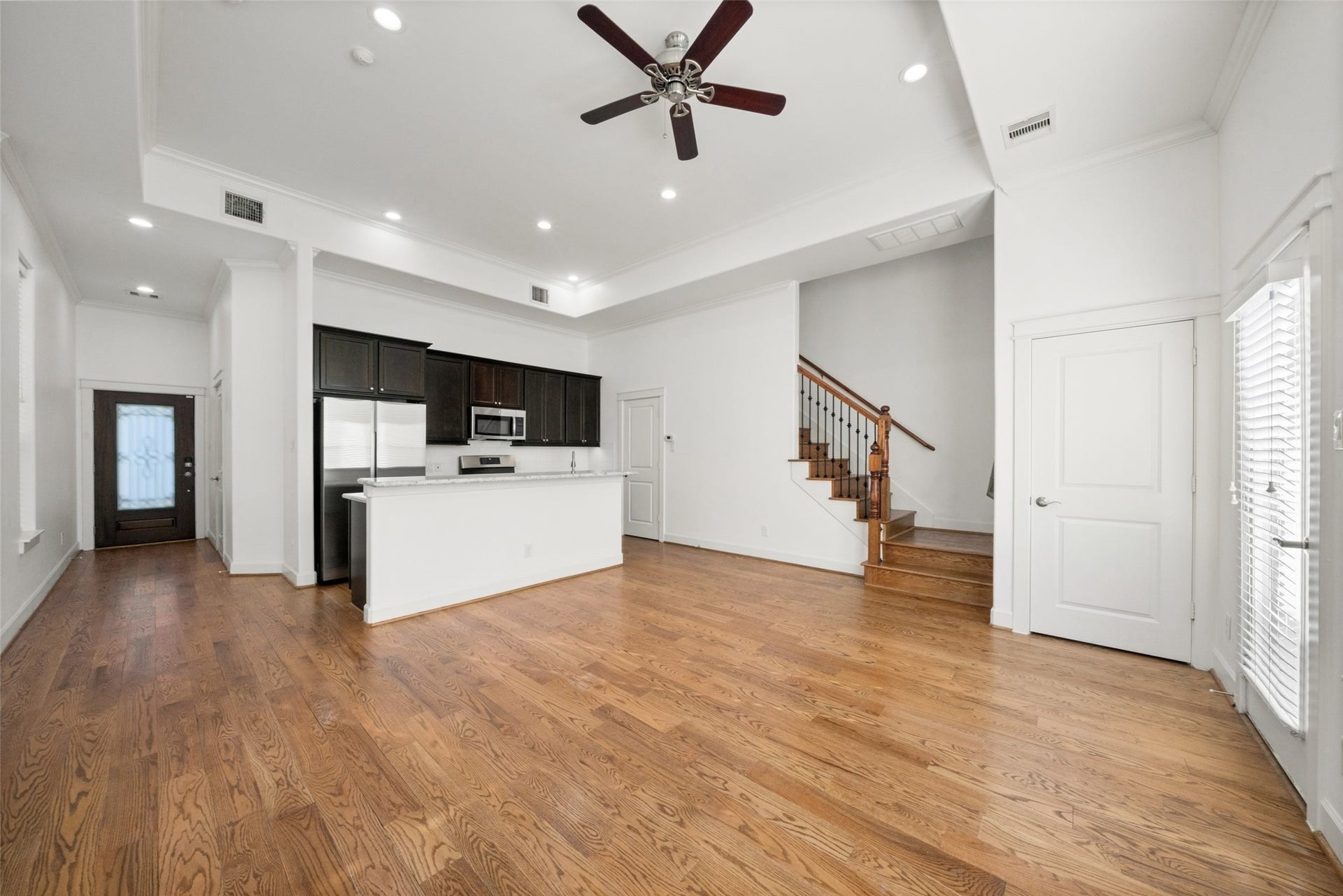 904 W 20th Street, #A, Houston, TX 77008 Another view of your living room, with access to your outdoor space through the door on the right. At the bottom of the stairs is one of your conveniently placed half baths.