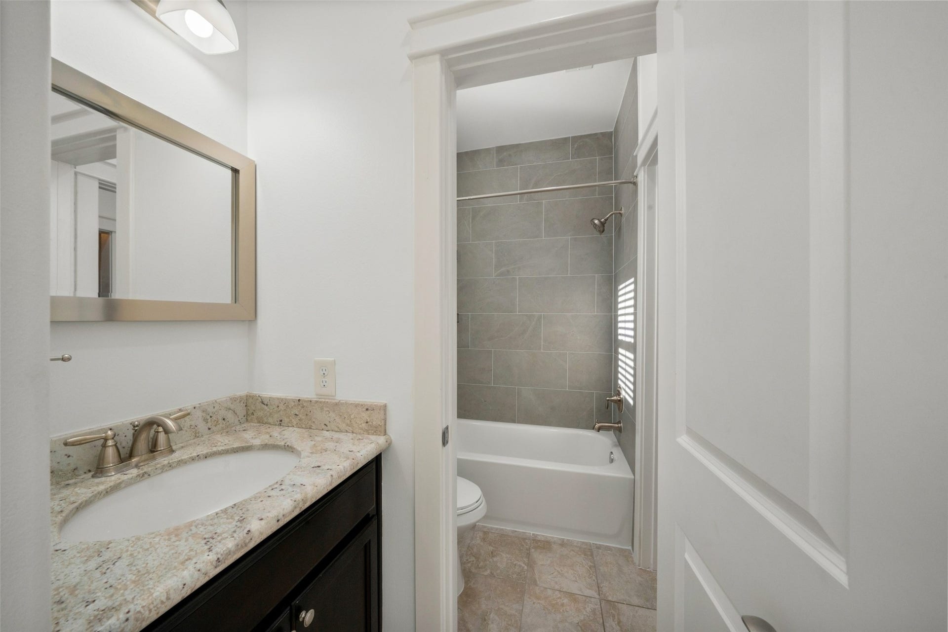 904 W 20th Street, #A, Houston, TX 77008 Bathroom access from the 3rd bedroom, not pictured is built in storage to the left. Through the doorway you can see the new tub and tiled shower surround!