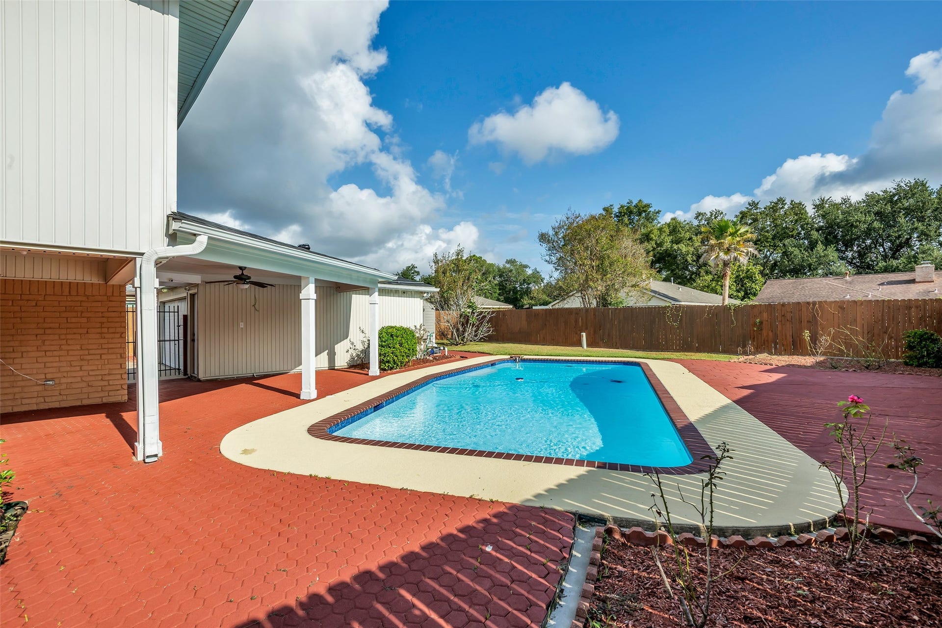 Gorgeous yard, pool and covered patio are perfect for outdoor fun.