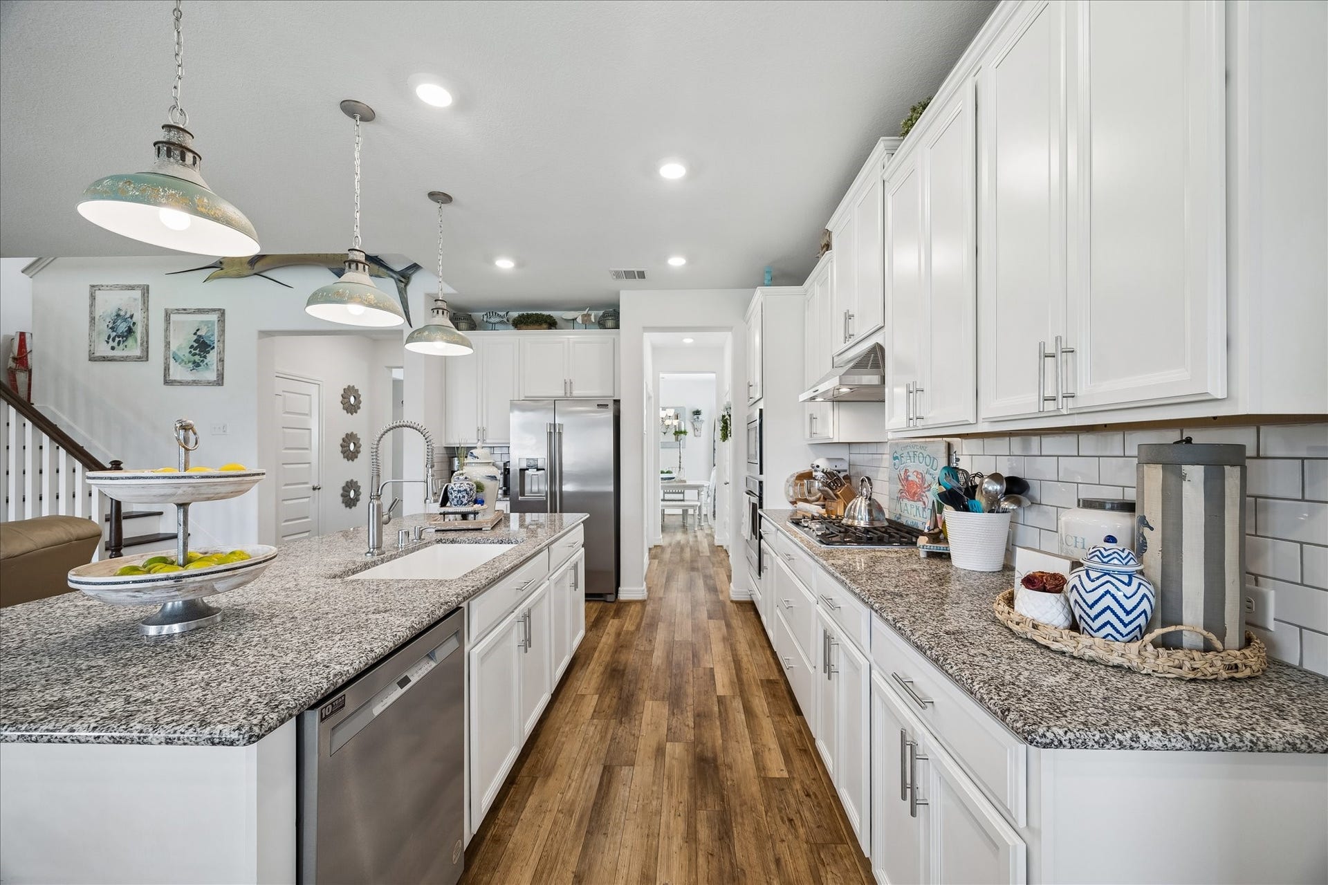 25934 Bronze Oak Court, Richmond, TX 77406 This bright, hardworking kitchen brings style and function together beautifully with crisp white cabinetry, granite counters, subway tile backsplash, sleek stainless-steel appliances and a wide pantry that keeps everyday essentials close at hand.