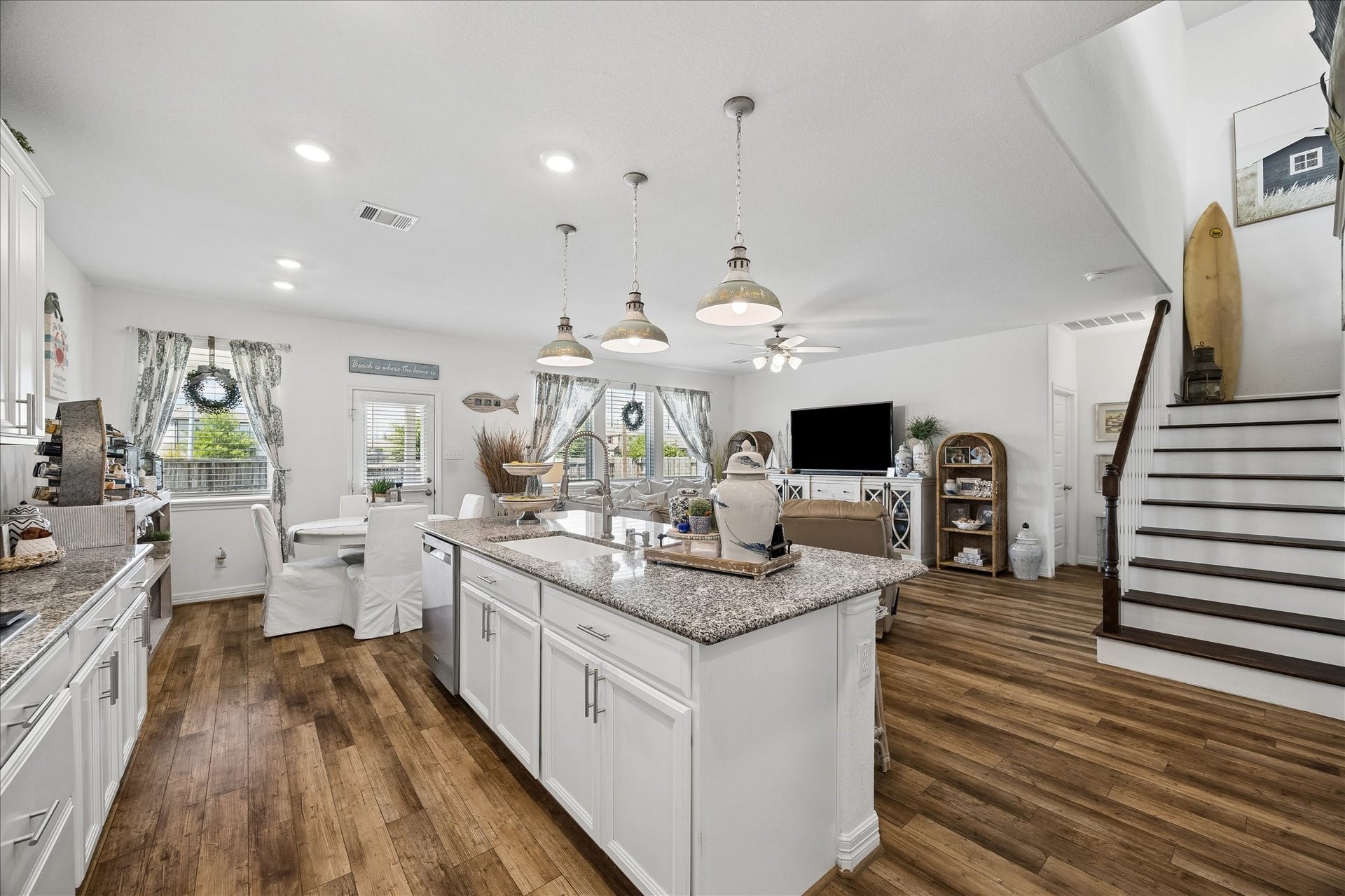 25934 Bronze Oak Court, Richmond, TX 77406 The oversized island is ready for everything from quick breakfasts to weekend entertaining with bar seating, pendant lighting, a deep basin sink and upgraded fixtures. Open views into the dining and living areas keep the whole space connected.