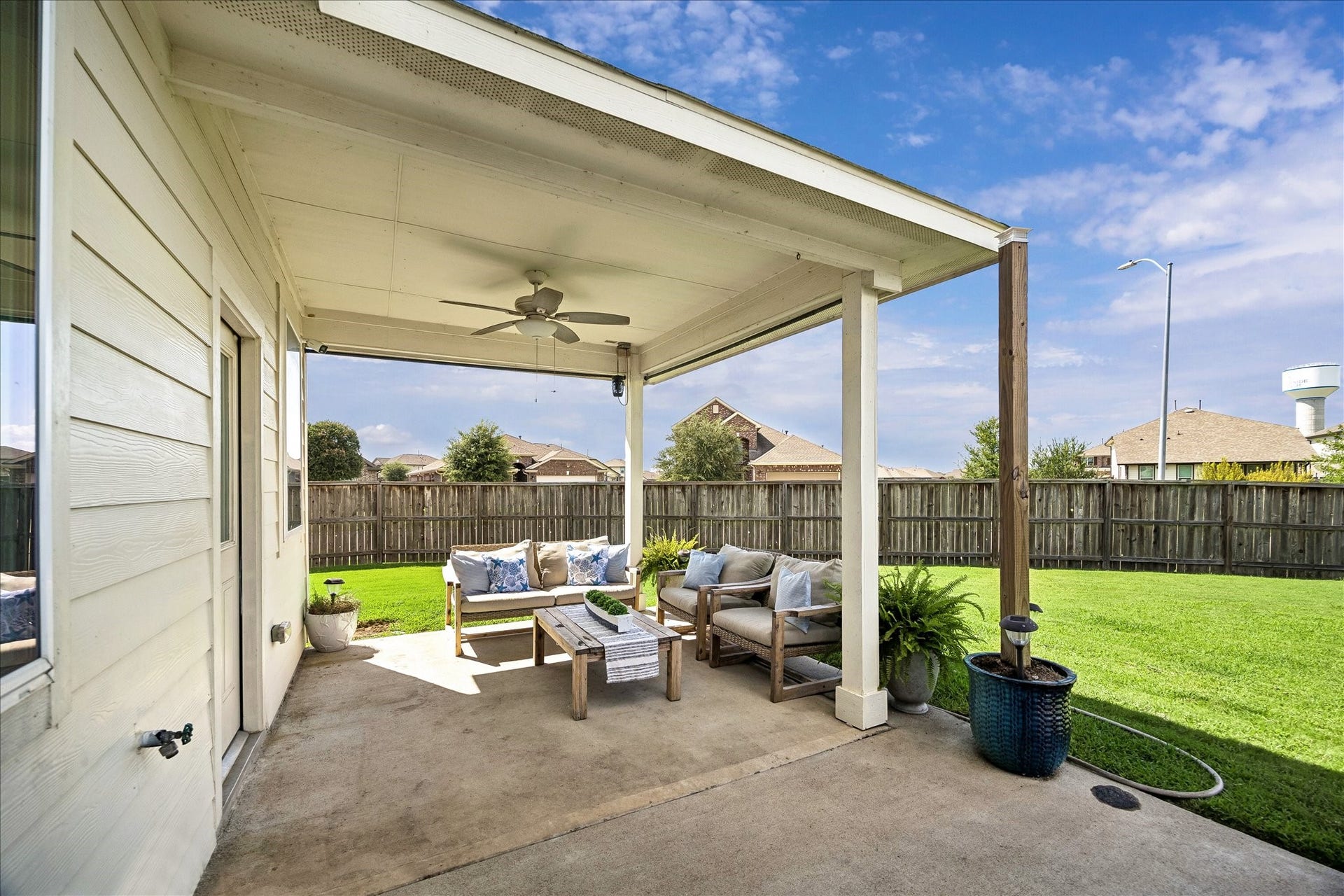 25934 Bronze Oak Court, Richmond, TX 77406 The covered patio with roll down shades and a cooling ceiling fan offers the perfect place to enjoy morning coffee, an evening nightcap and everything in between in comfort throughout the year.