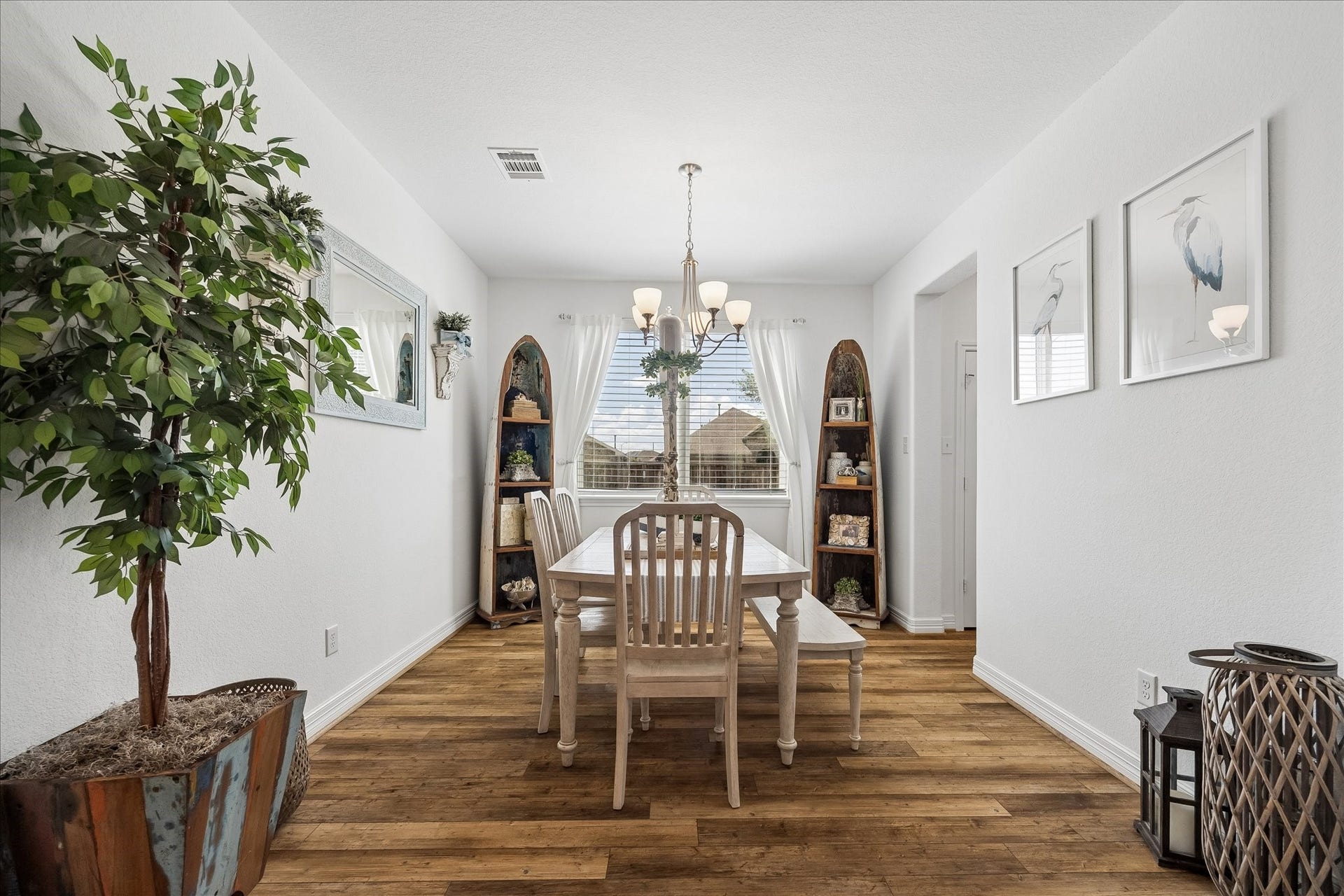 25934 Bronze Oak Court, Richmond, TX 77406 The formal dining room offers the perfect backdrop for every occasion with rich LVP flooring, a stylish chandelier and plenty of room for your banquet table and sideboard.