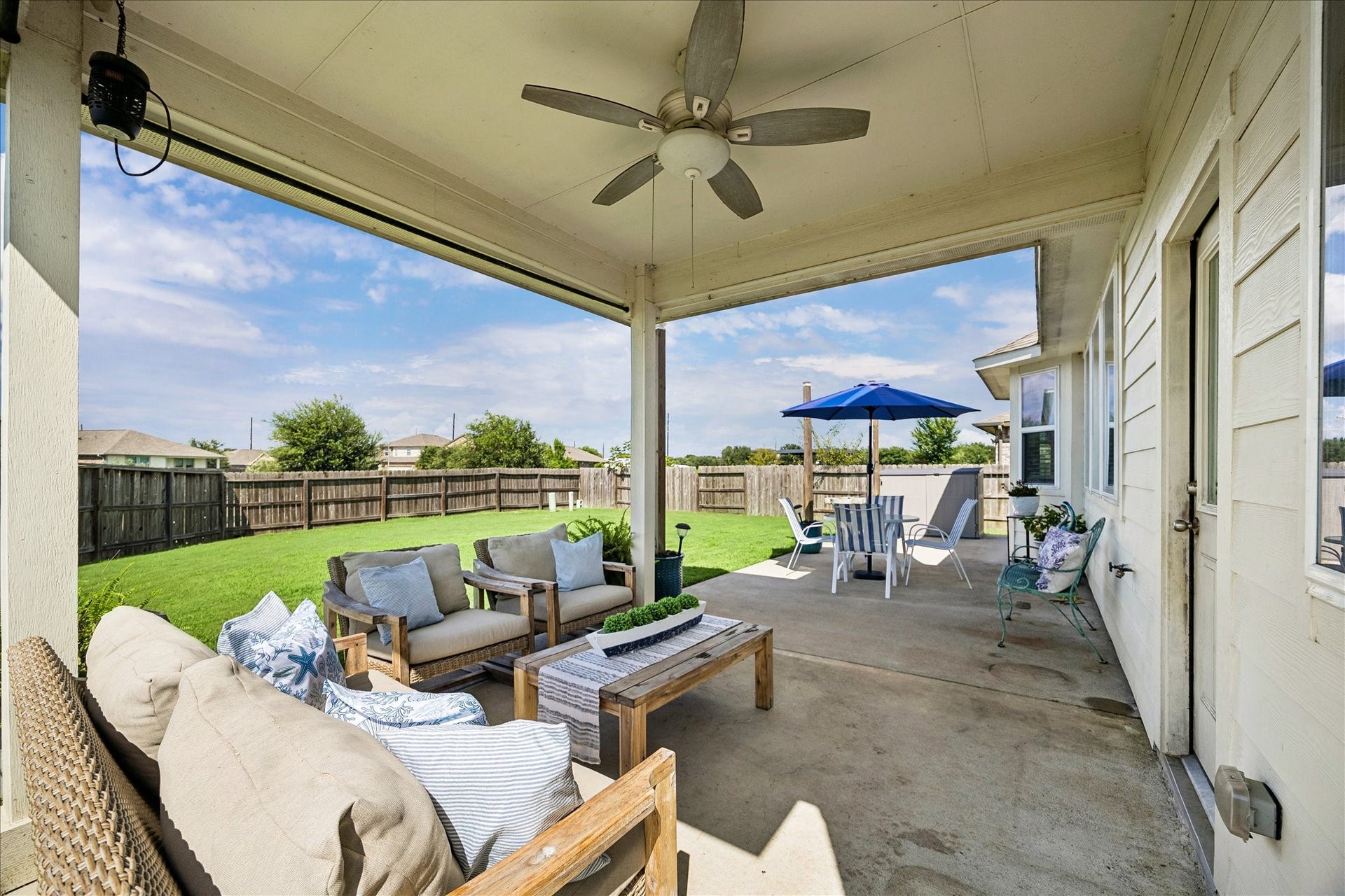 25934 Bronze Oak Court, Richmond, TX 77406 Stretch out and settle in on this spacious covered patio, where roll down shades and a cooling ceiling fan create a comfortable retreat for morning coffee, casual meals and relaxed evenings, while the nearby uncovered patio offers the perfect spot to soak up a little sunshine.
