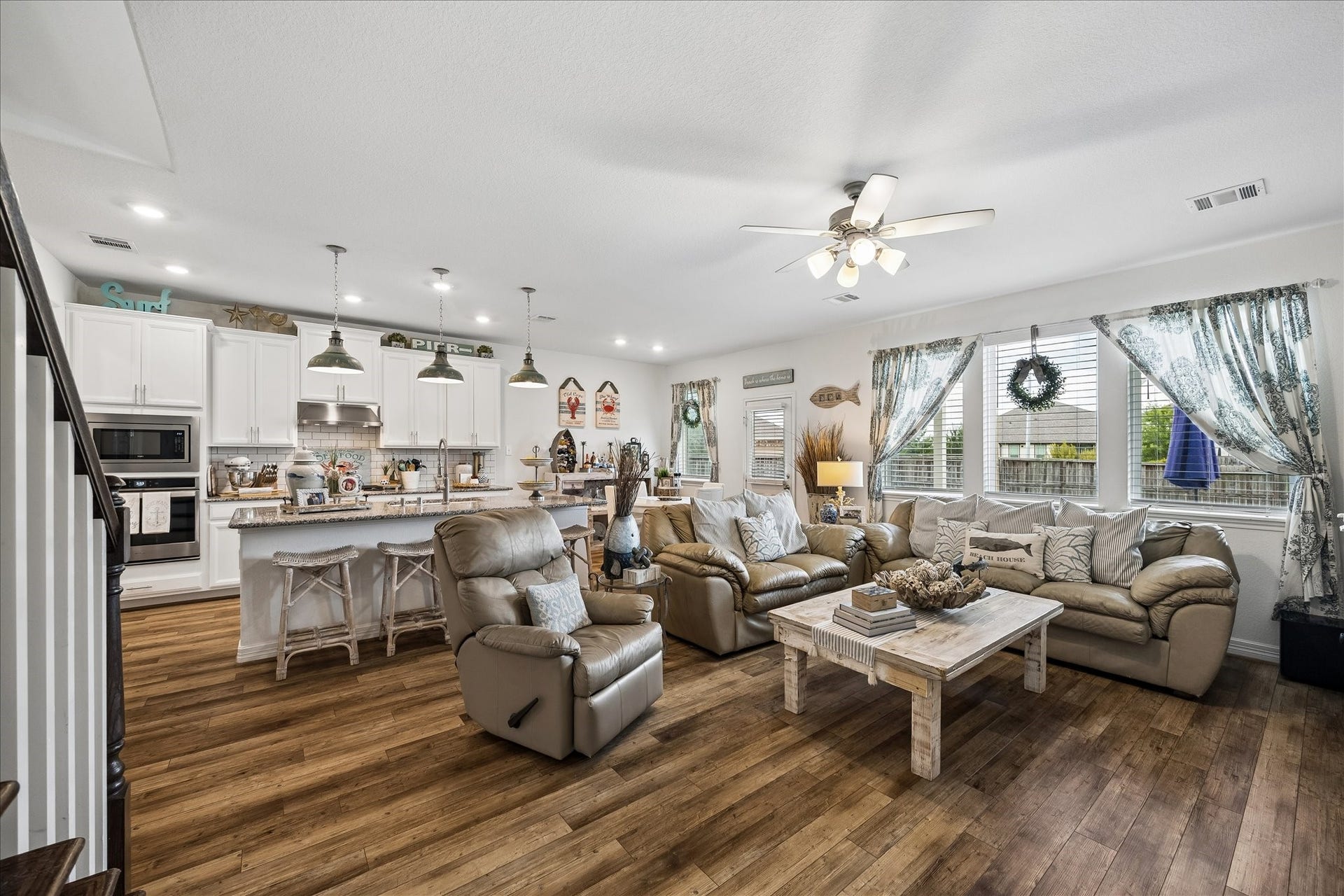 25934 Bronze Oak Court, Richmond, TX 77406 Large windows fill the room with soft natural light, while the door opens to the covered patio and sprawling fenced yard, creating an easy flow for outdoor dining, playtime and weekend entertaining.