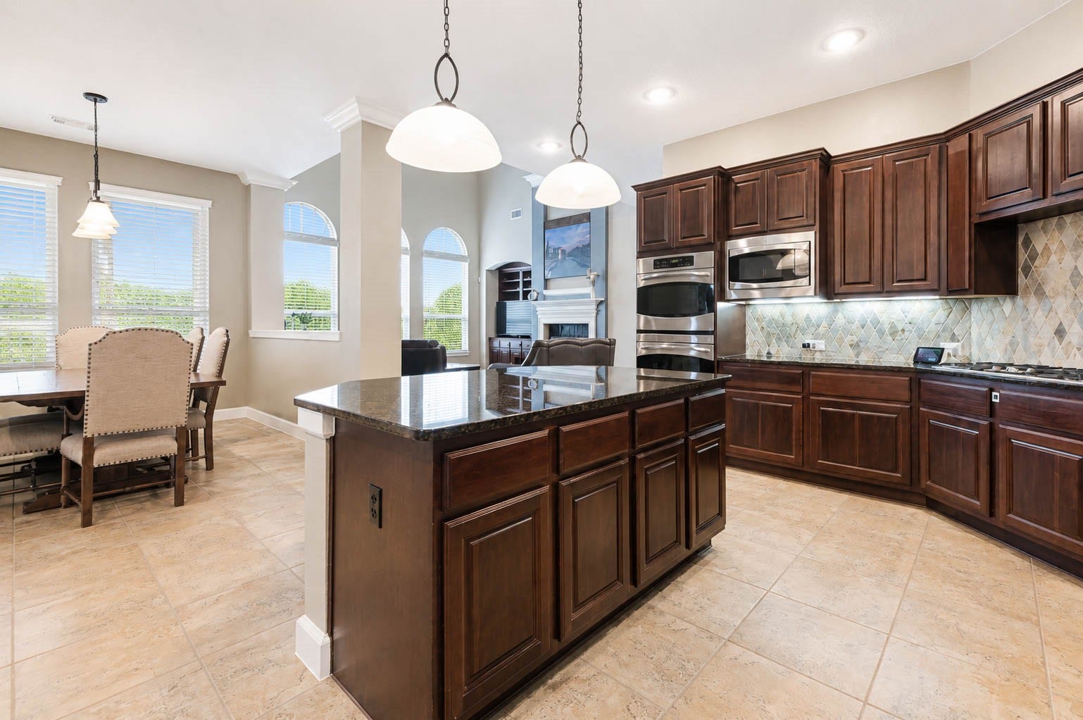 5331 W Farm Way, Fulshear, TX 77441 The island offers cabinetry and drawers for additional storage, eye catching pendant lighting, and space for barstool seating. The gas cooktop completes this well appointed kitchen.