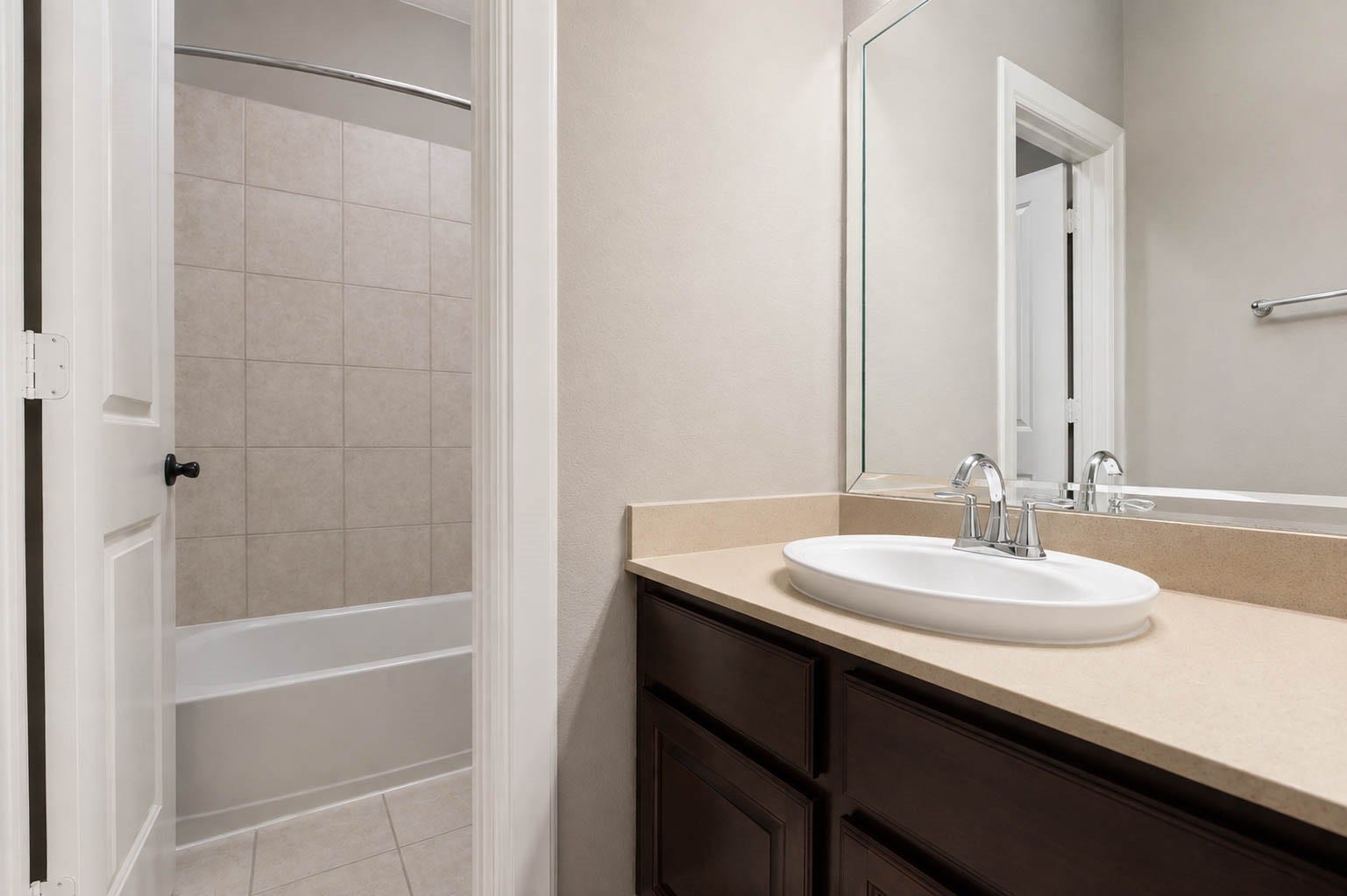 5331 W Farm Way, Fulshear, TX 77441 Guests will love this clean and crisp full bathroom, featuring a large vanity, framed mirror, and a tub and shower combination.
