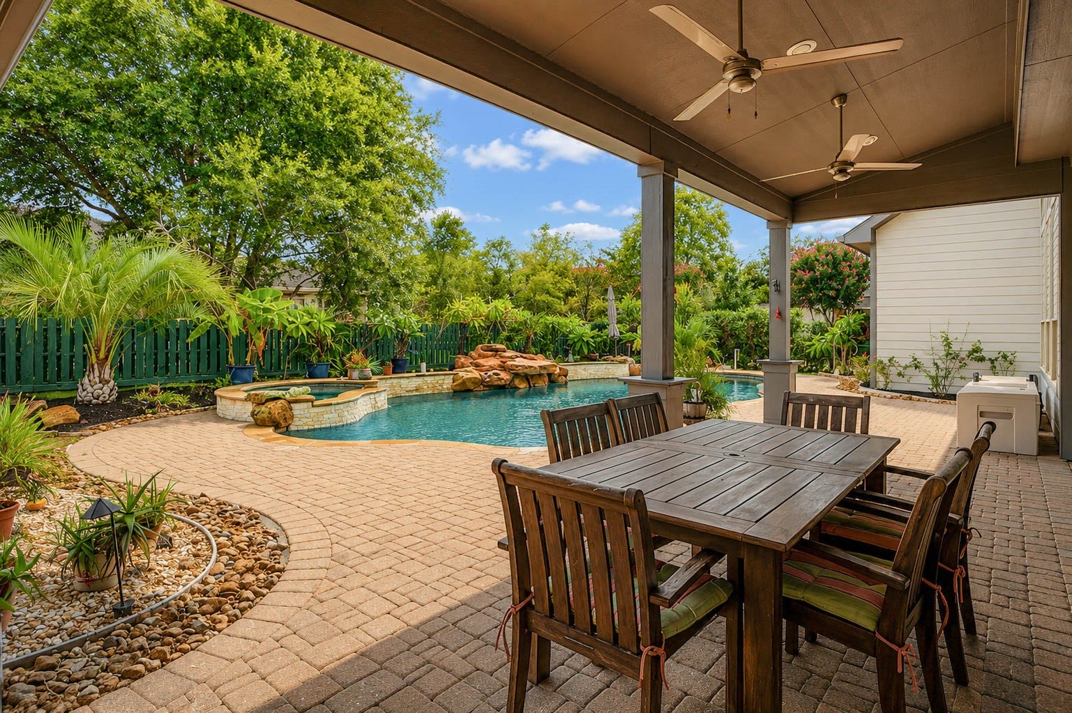5331 W Farm Way, Fulshear, TX 77441 Step outside to find the perfect place to relax and unwind! The backyard is a dream, with lush landscaping, stunning pavers, and a large covered patio complete with multiple ceiling fans for year round comfort.