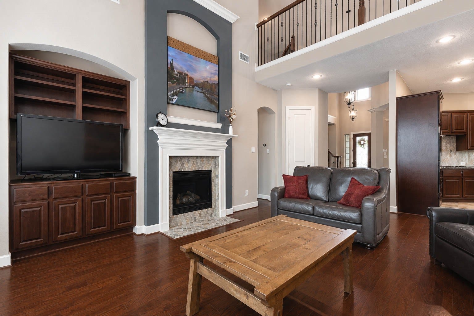 5331 W Farm Way, Fulshear, TX 77441 To the left of the fireplace, a custom built in with open shelving and cabinetry offers ample storage for media equipment, games, and more, while the shelves provide a beautiful spot to display favorite decor.