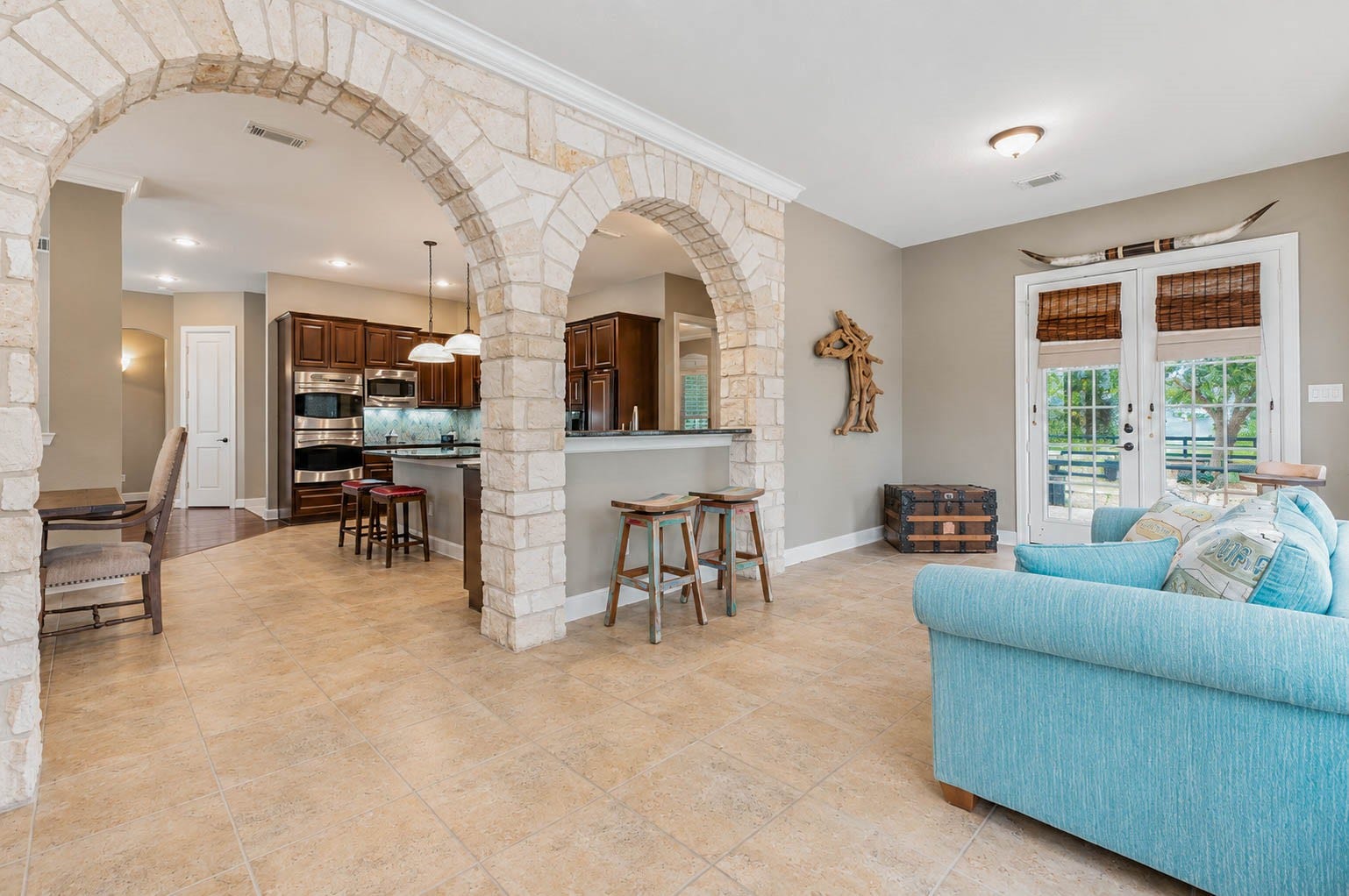 5331 W Farm Way, Fulshear, TX 77441 The sunroom offers plenty of room to make the space your own, with double doors providing direct access to the backyard.