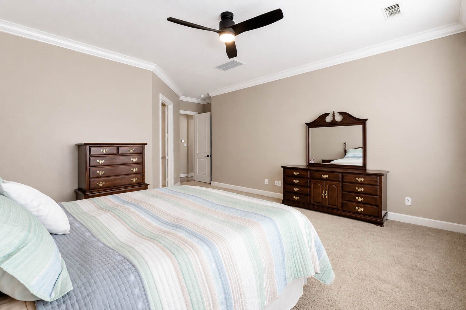 5331 W Farm Way, Fulshear, TX 77441 The primary bedroom offers plenty of room for a king size bedroom set and more, with an eye catching upgraded ceiling fan.