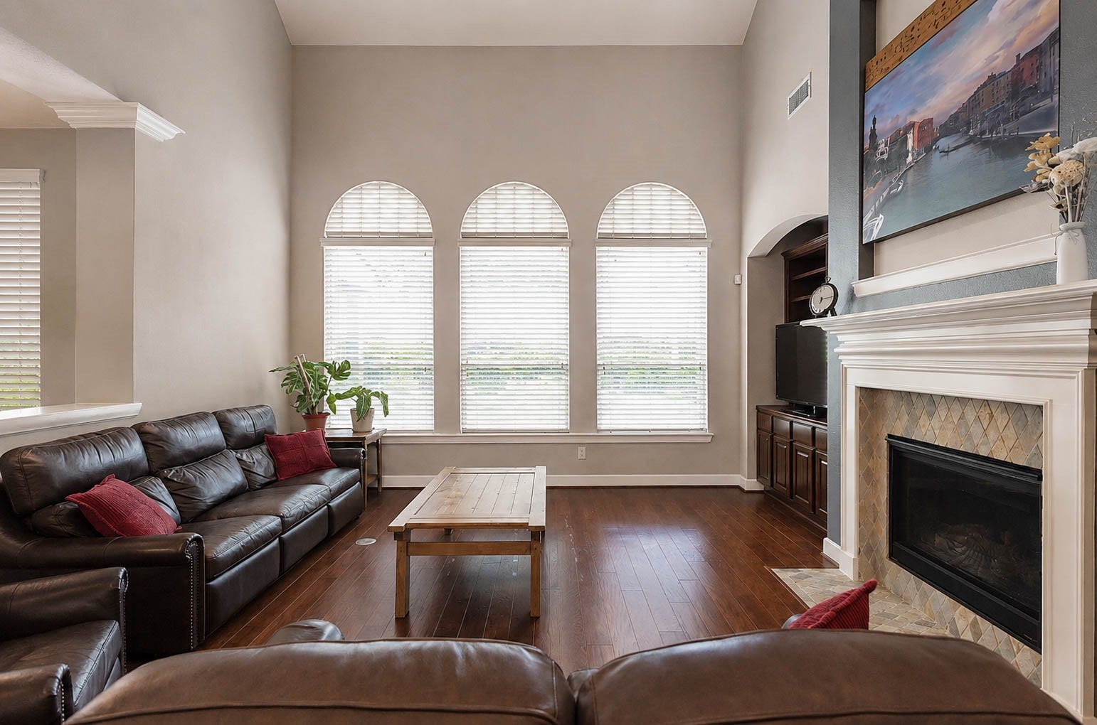 5331 W Farm Way, Fulshear, TX 77441 The living room offers a welcoming place to unwind, centered around a cozy fireplace with soaring ceilings and plenty of space for a large seating arrangement.