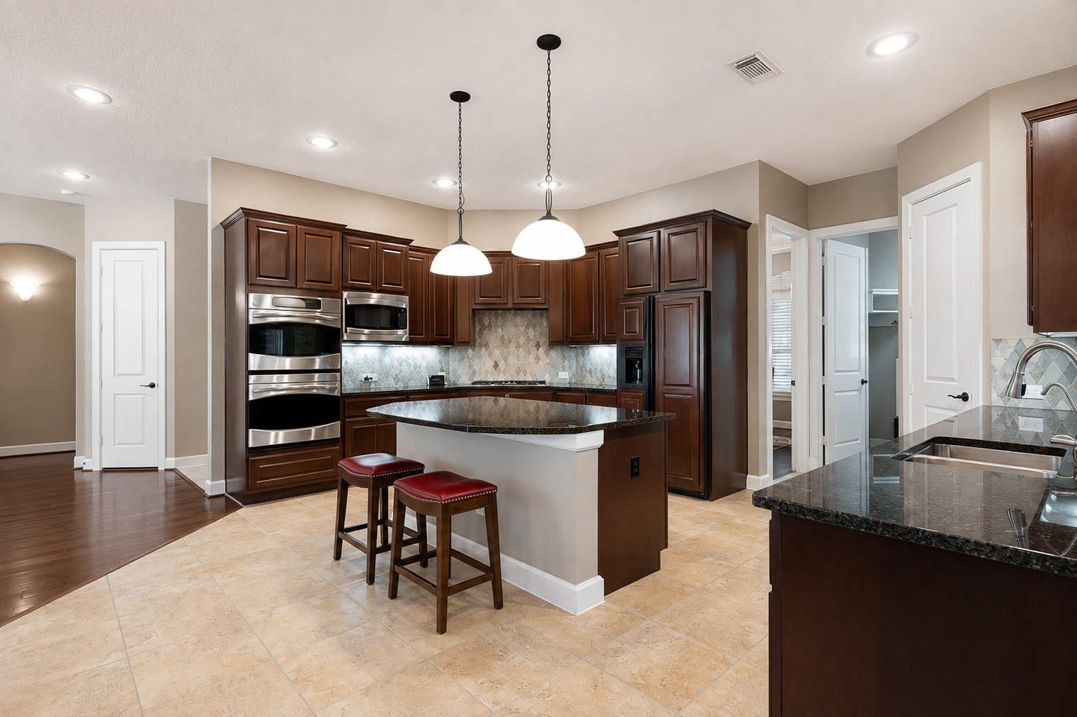 5331 W Farm Way, Fulshear, TX 77441 Additional kitchen features include ceramic tile flooring, recessed lighting, and gorgeous cabinetry, along with stainless steel appliances such as double ovens and a built in microwave.