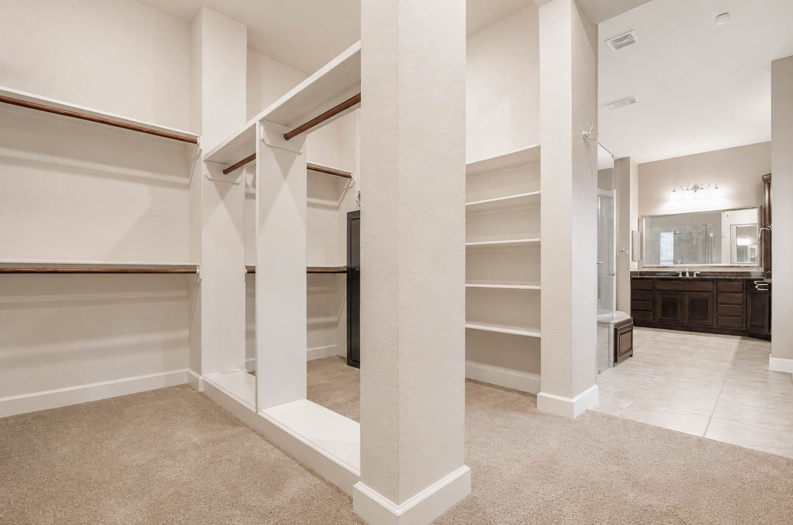5331 W Farm Way, Fulshear, TX 77441 This impressive walk in closet is complete with built in shelving and multiple hanging racks, offering plenty of room for a large wardrobe!
