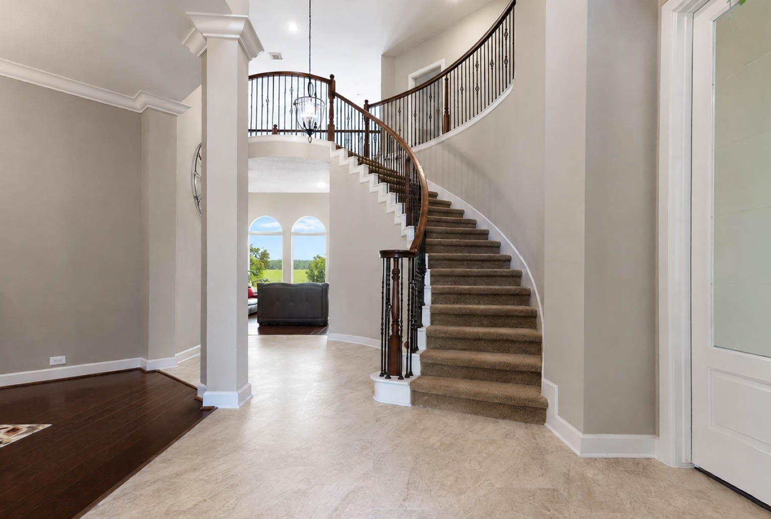 5331 W Farm Way, Fulshear, TX 77441 Welcome in! The grand two-story foyer soars to 20 feet and showcases a graceful spiral staircase, wrought iron balusters, and approximately 200 square feet of large format Italian ceramic tile underfoot.