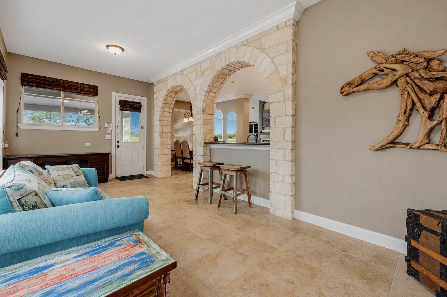 5331 W Farm Way, Fulshear, TX 77441 This approximately 260 square foot sunroom offers ceramic tile flooring and a wonderful place to relax, framed by the home's signature stone arches.