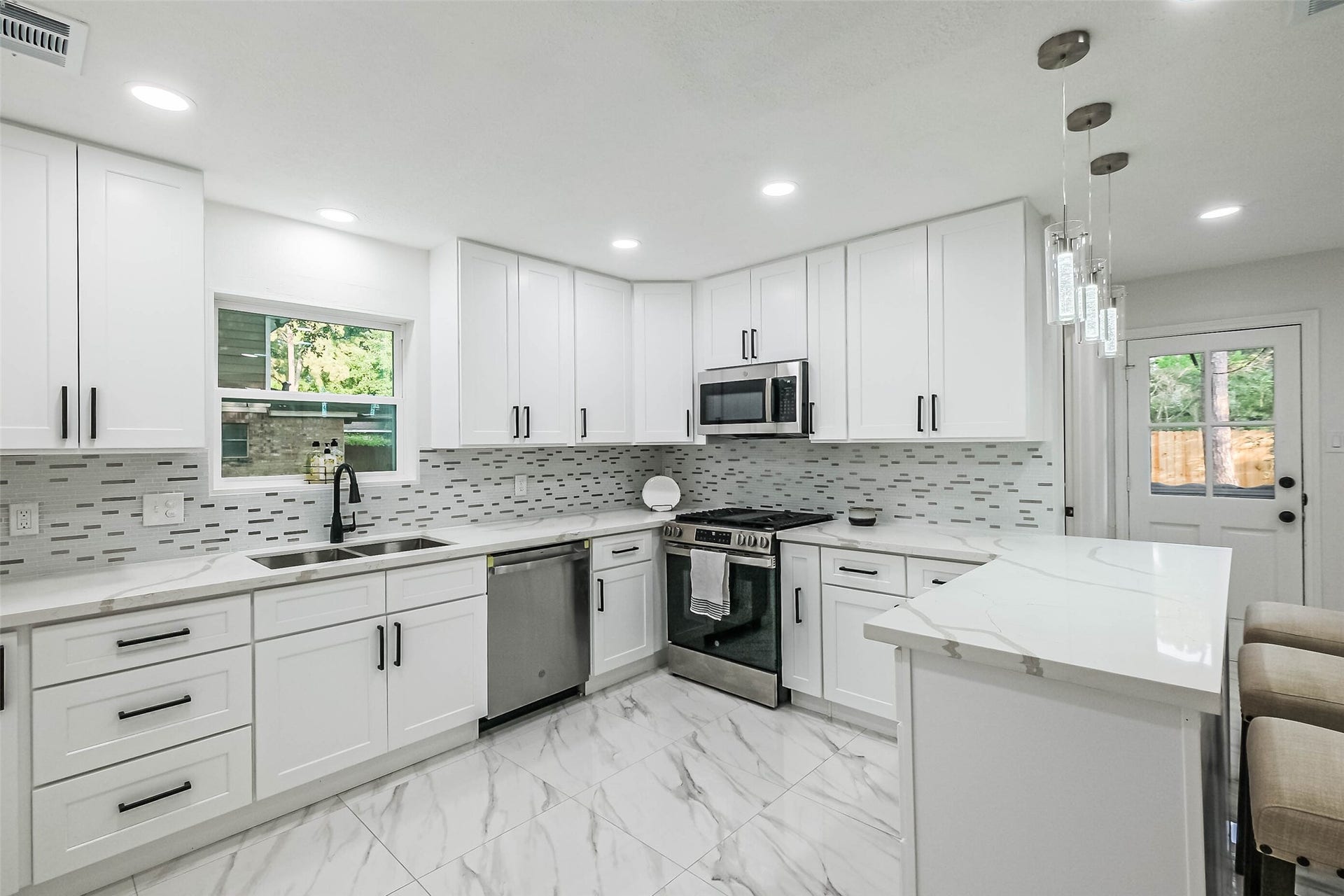 The kitchen has been totally updated with new countertops, flooring, appliances and cabinets.