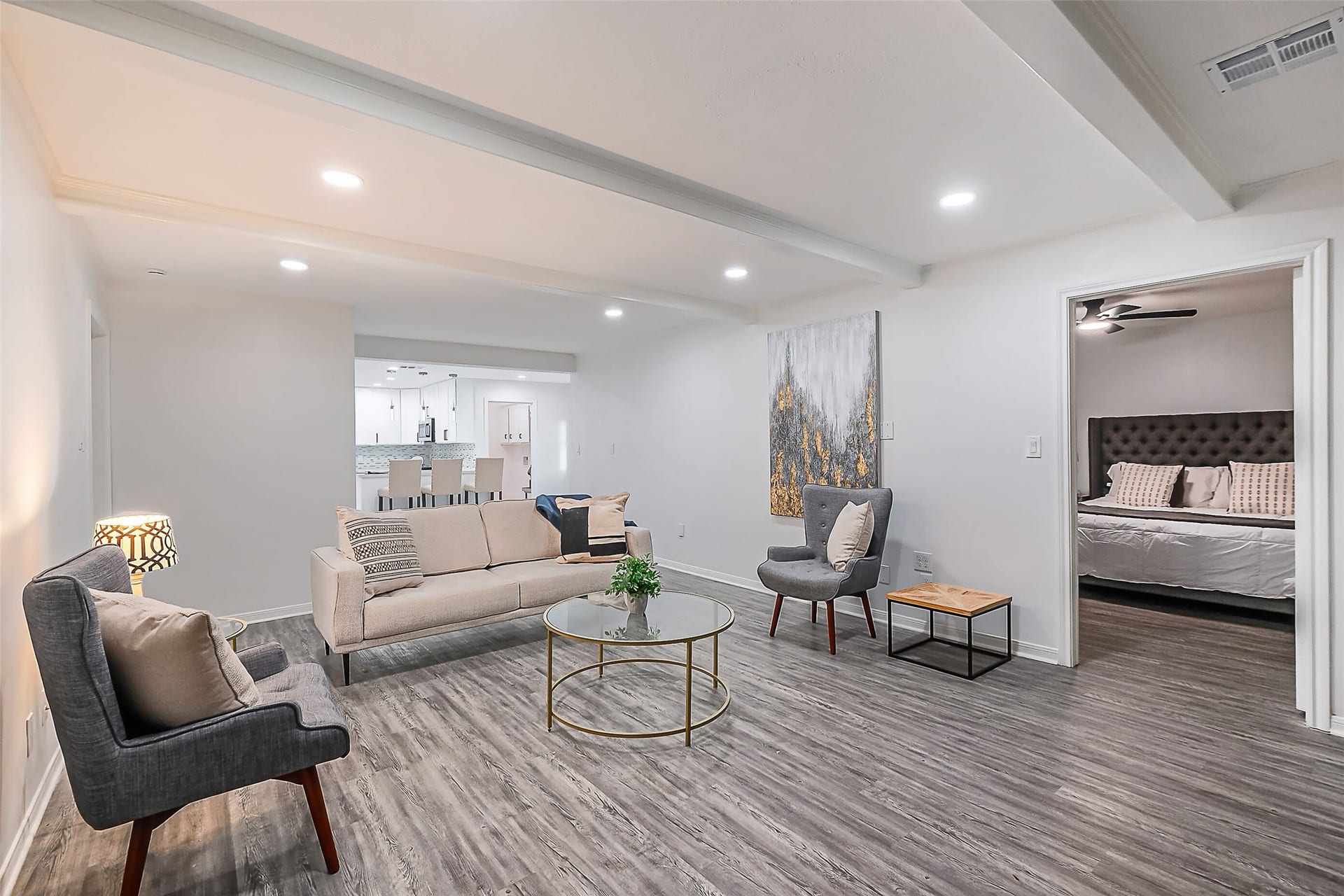 The living room with the breakfast nook and kitchen behind.