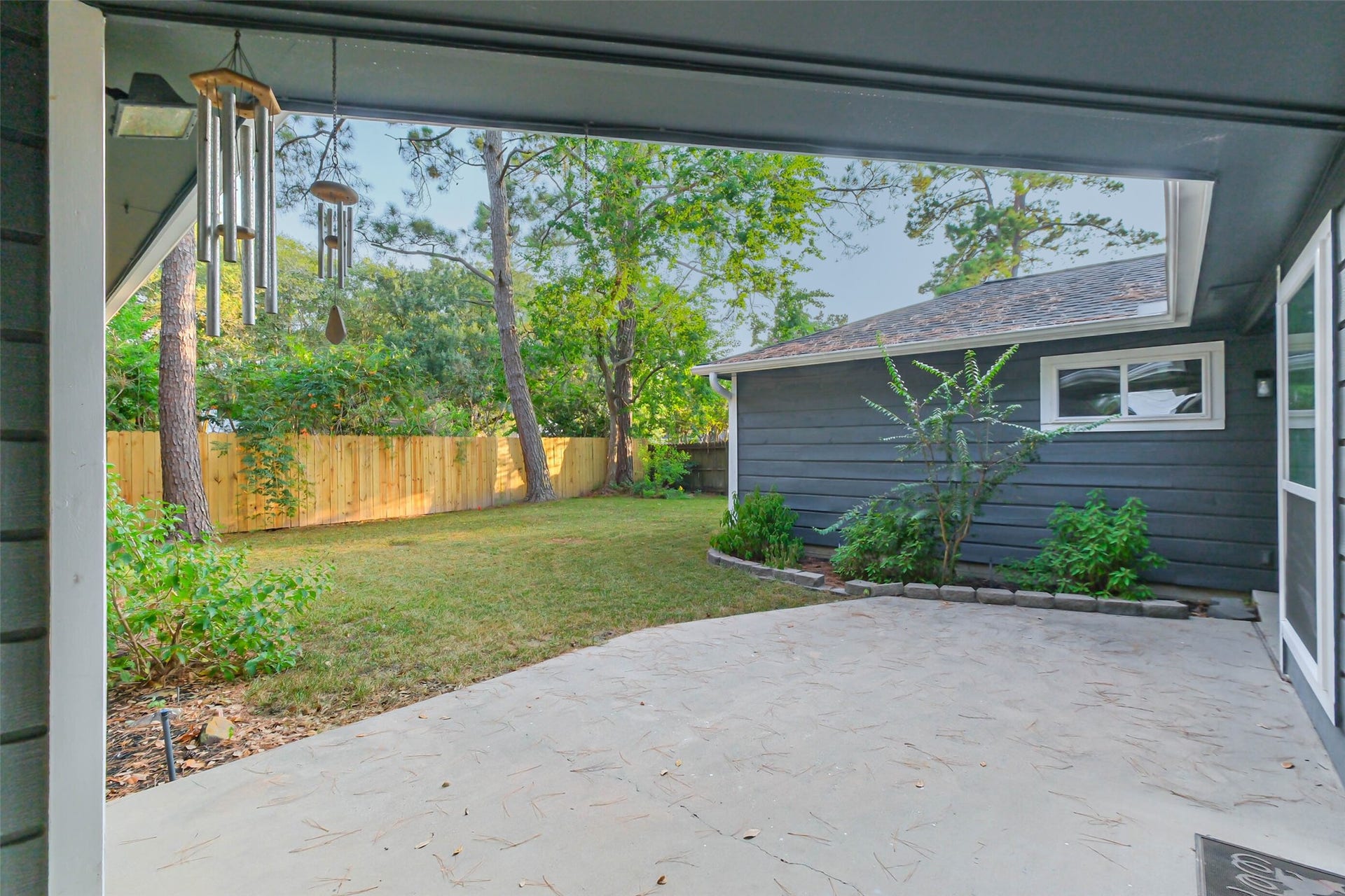 The backyard enjoys this pleasant patio area. There is new fencing around the backyard.