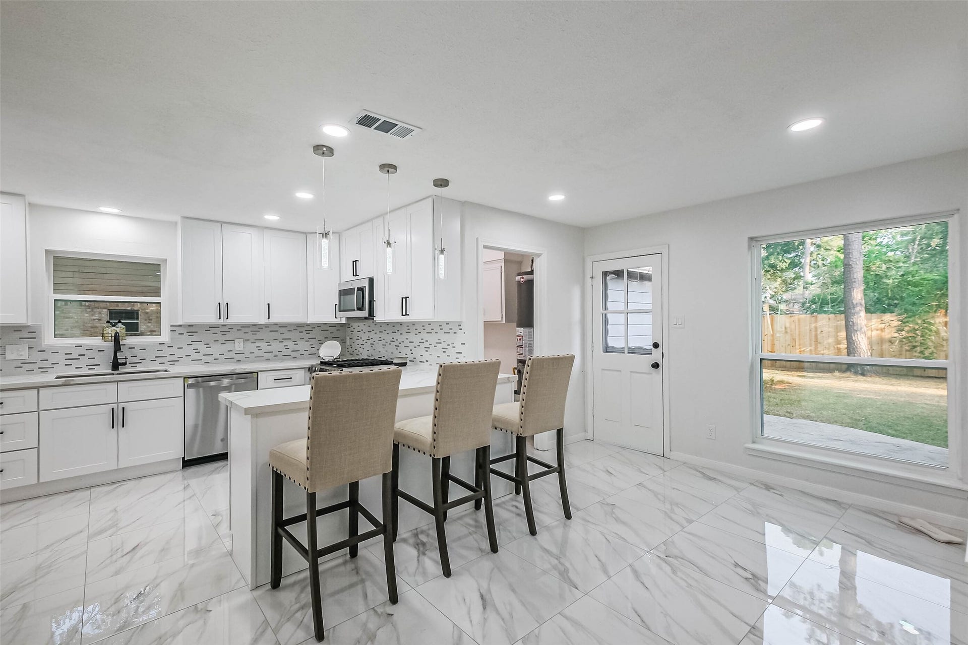 The breakfast nook enjoys lovely views of the backyard. The kitchen high counter has seating for 3 / 4 high chairs.