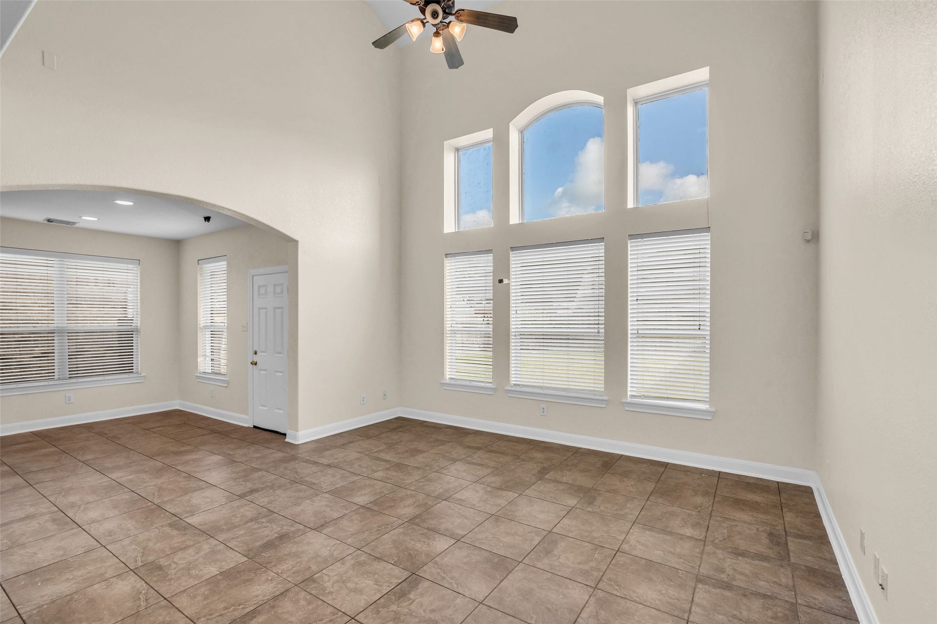 9907 Heritage Waters Court, Humble, TX 77396 Large windows provide abundant light in the living area, a large space for entertaining. Tile runs throughout the main living areas.
