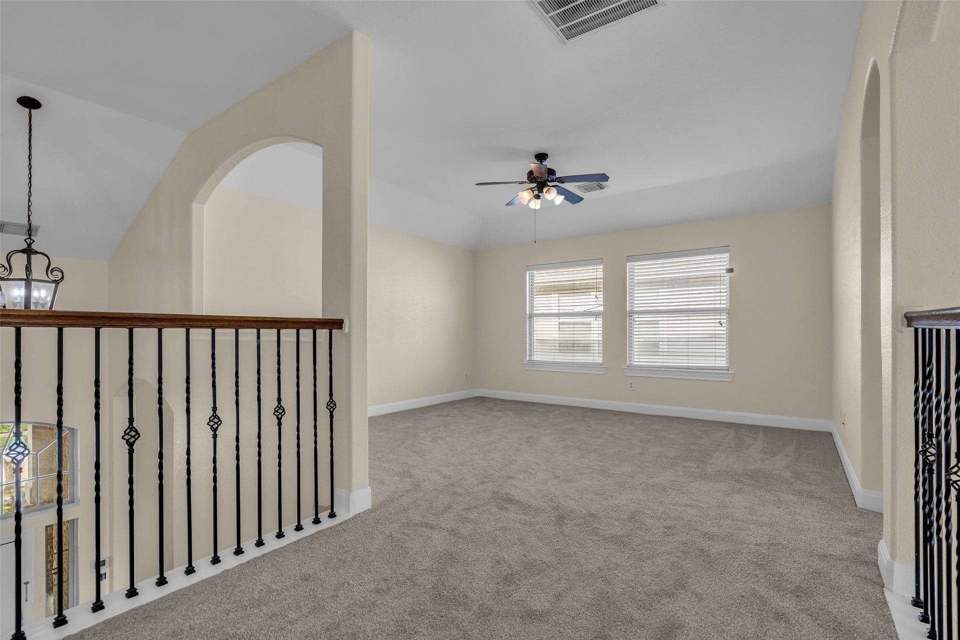 9907 Heritage Waters Court, Humble, TX 77396 Upgraded wrought iron railing is shown on the stairs on in the landing.