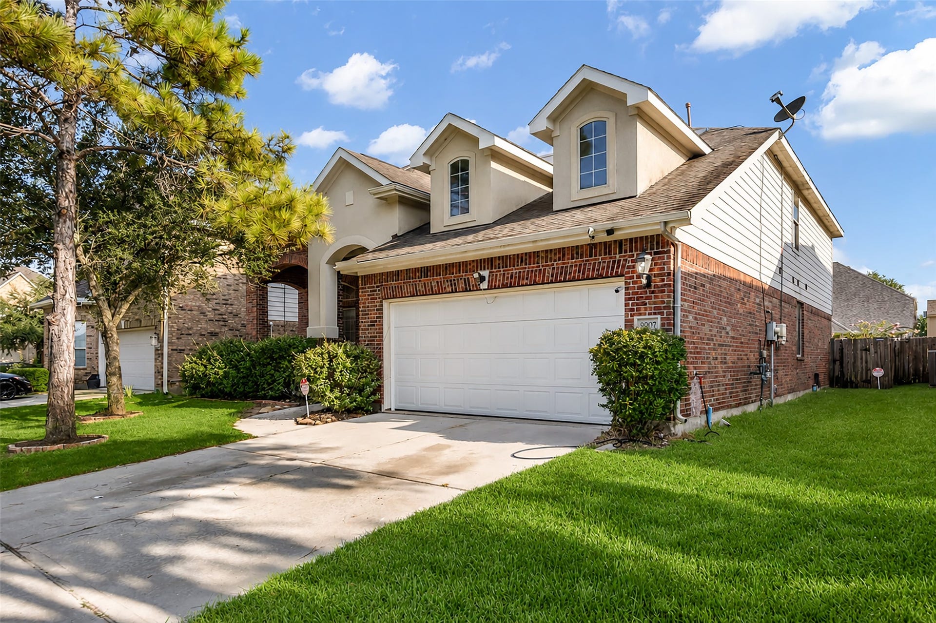 9907 Heritage Waters Court, Humble, TX 77396 A new garage door has recently been added. Solar panels are present on the roof.
