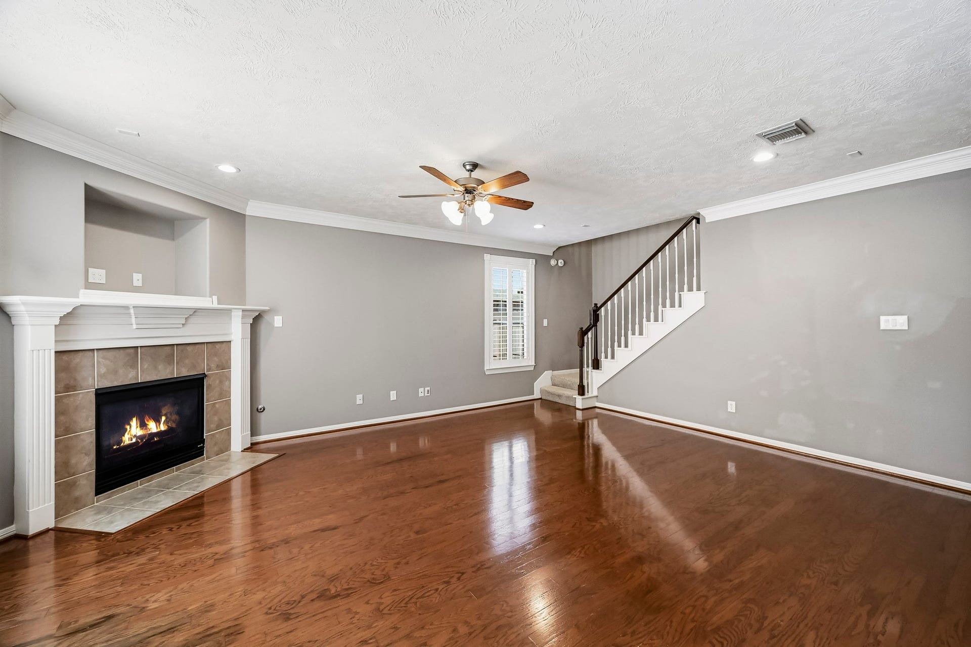 951 Lamonte Lane, Houston, TX 77018 Spacious family room with beautiful hardwood floors, a gas fireplace, crown molding, and plantation shutters.