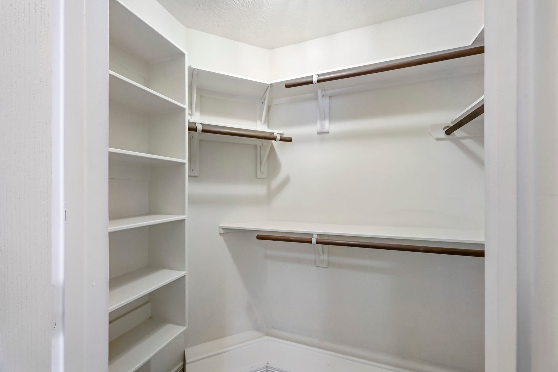 951 Lamonte Lane, Houston, TX 77018 Spacious walk-in primary closet featuring built-in shelving, multiple hanging rods, and plenty of storage to keep everything organized.