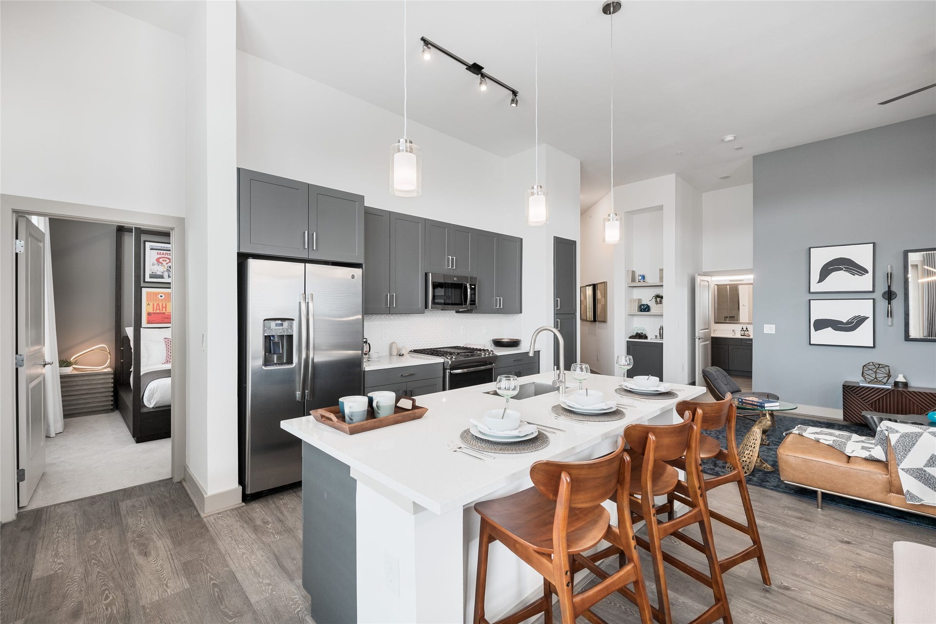 The kitchen is truly the heart of this home. A generous quartz island invites morning coffee, casual meals and conversations that linger. Sleek cabinetry, stainless steel appliances and elegant pendant lighting make everyday living feel a little more special. *Pictures are from a similar unit.