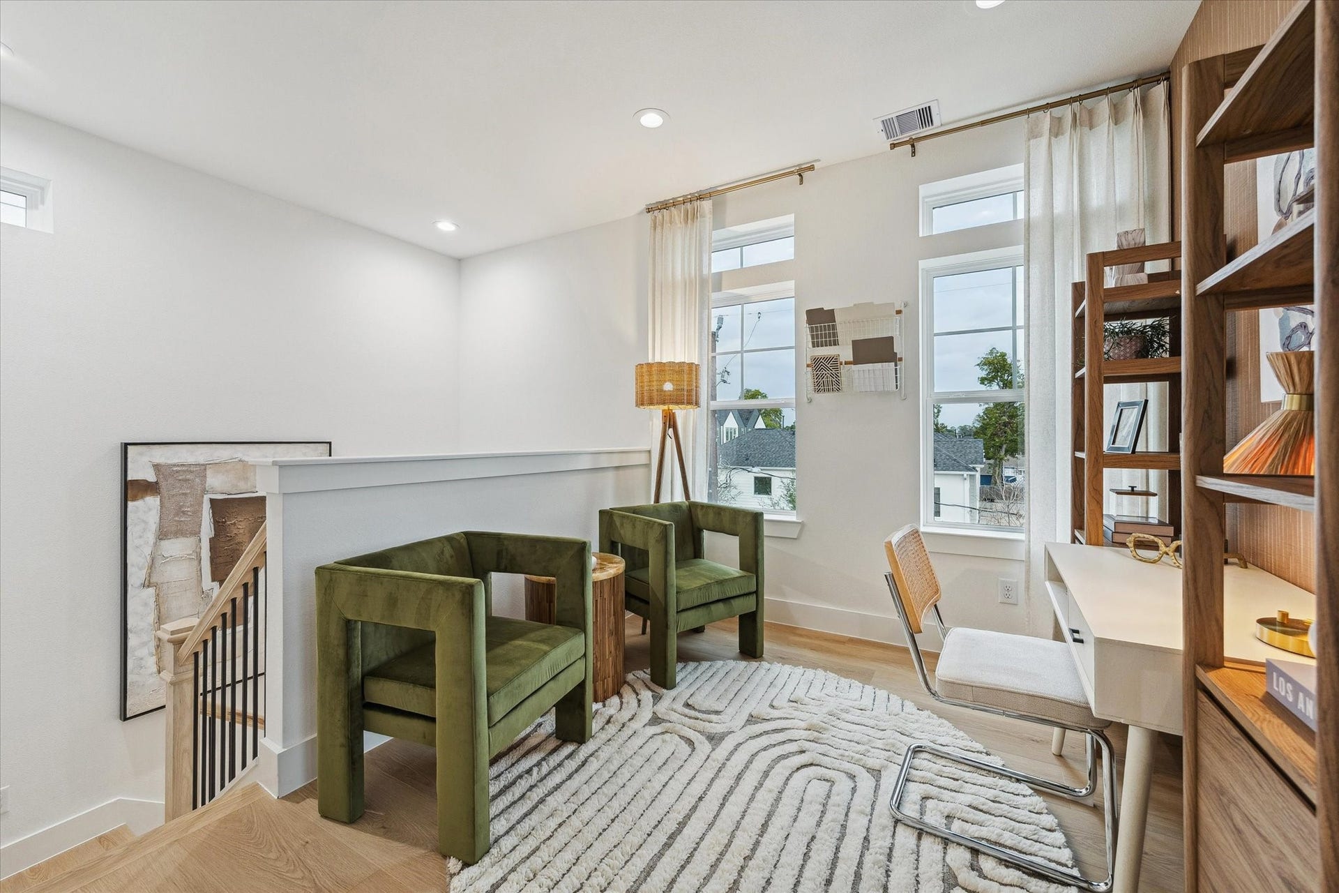 Bright and inviting loft space featuring modern decor, large windows for natural light, and a cozy seating area ideal for relaxation or work.