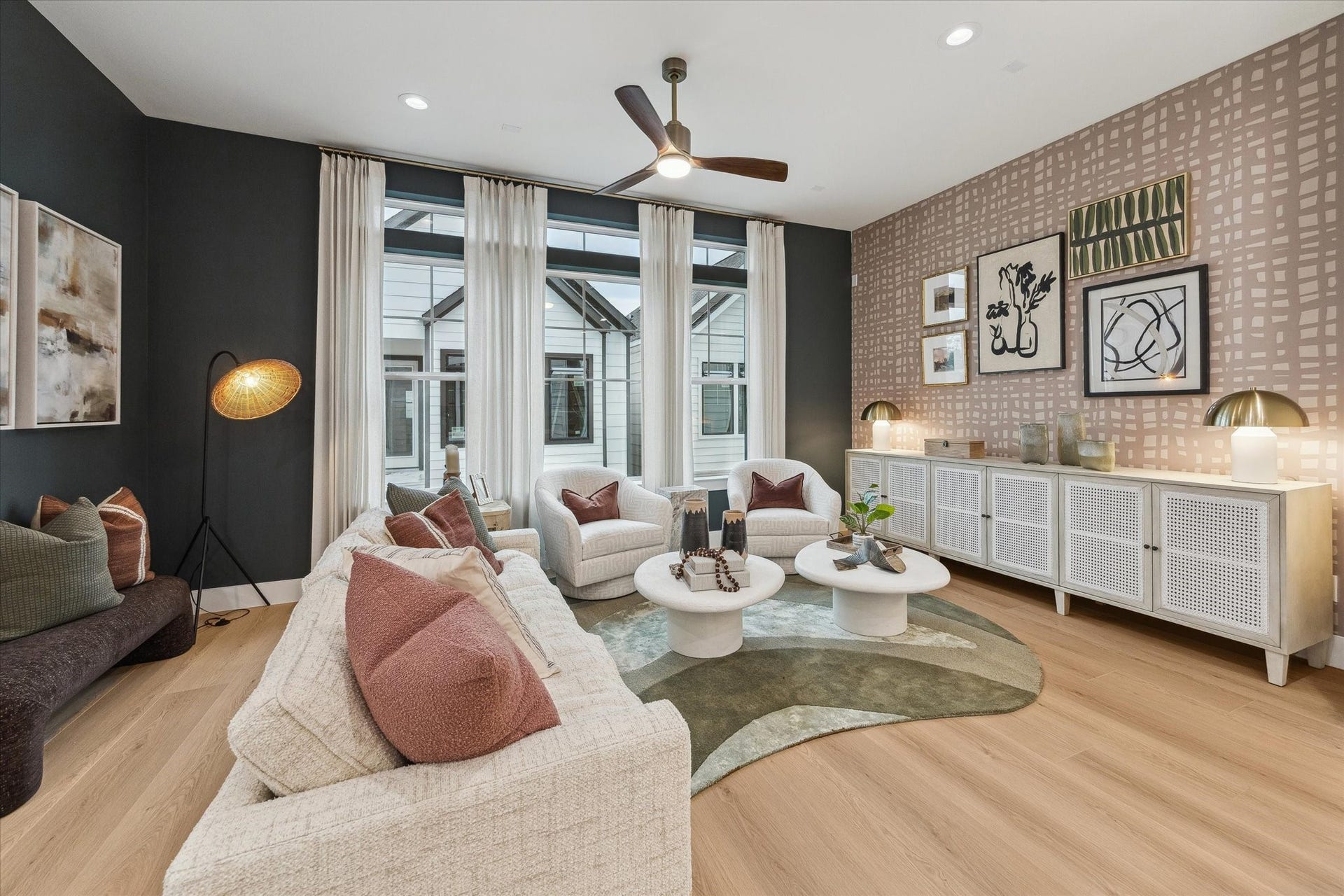 Stylish and inviting living room featuring modern decor, a cozy seating area, and abundant natural light from large windows.