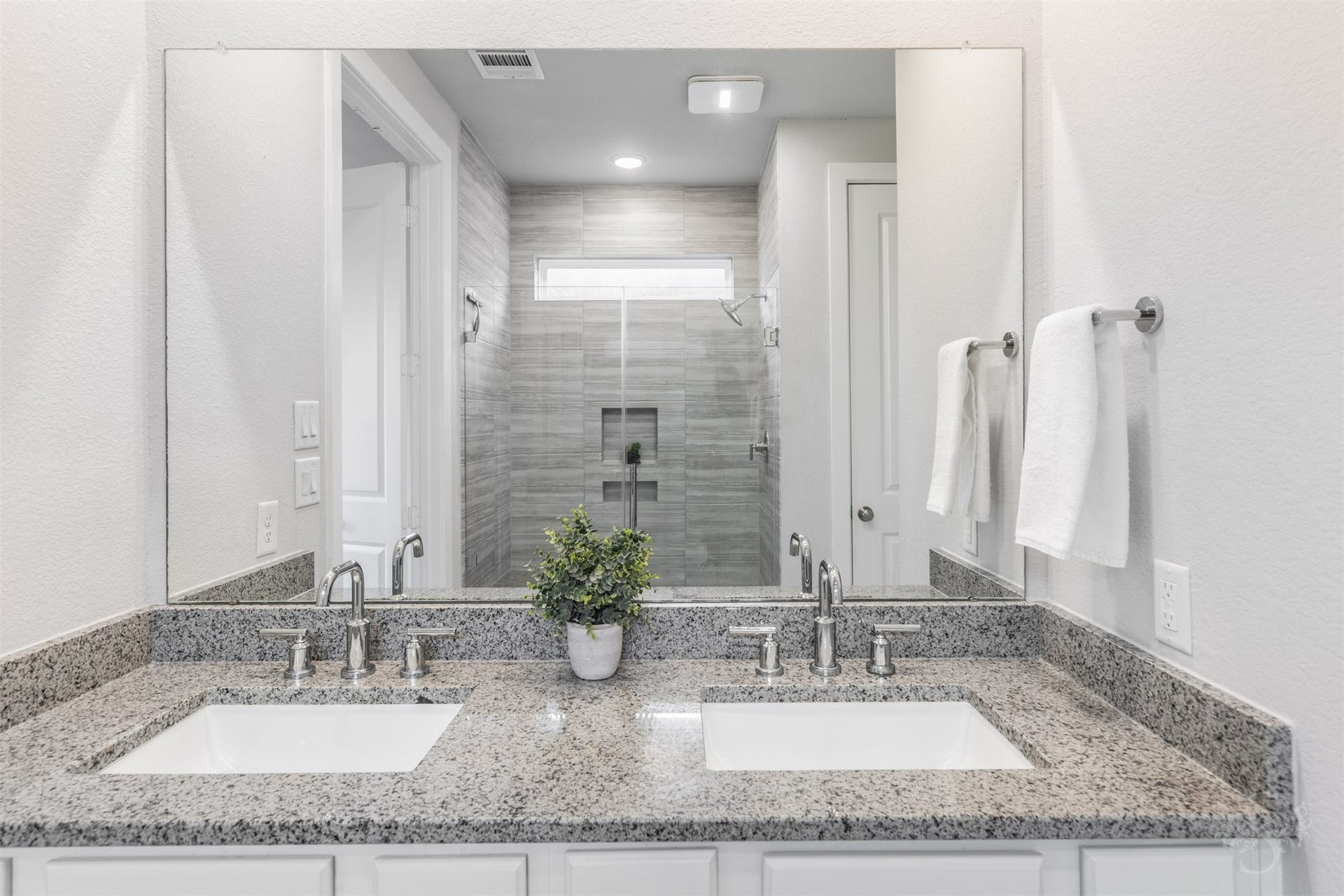 20922 Maudine Drive, Cypress, TX 77433 Dual undermount sinks and polished chrome fixtures complement the primary baths gorgeous granite vanity. An expansive mirror stretches above the counter, while cabinetry below keeps everyday essentials neatly tucked away.