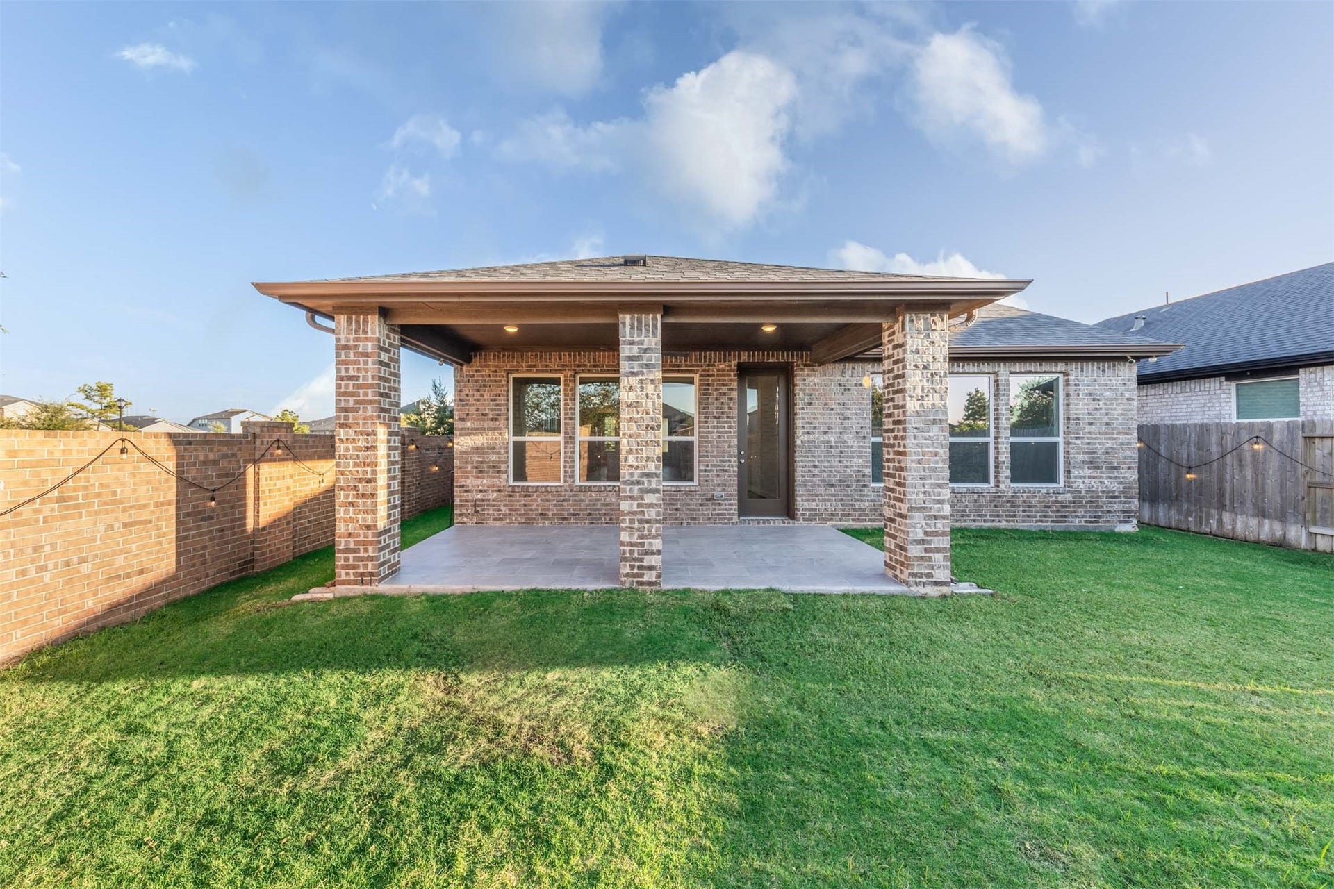 20922 Maudine Drive, Cypress, TX 77433 The spacious back yard offers plenty of green space for playing, gardening or enjoying the sunshine. A covered patio framed by brick columns provides an inviting spot to relax or entertain friends.