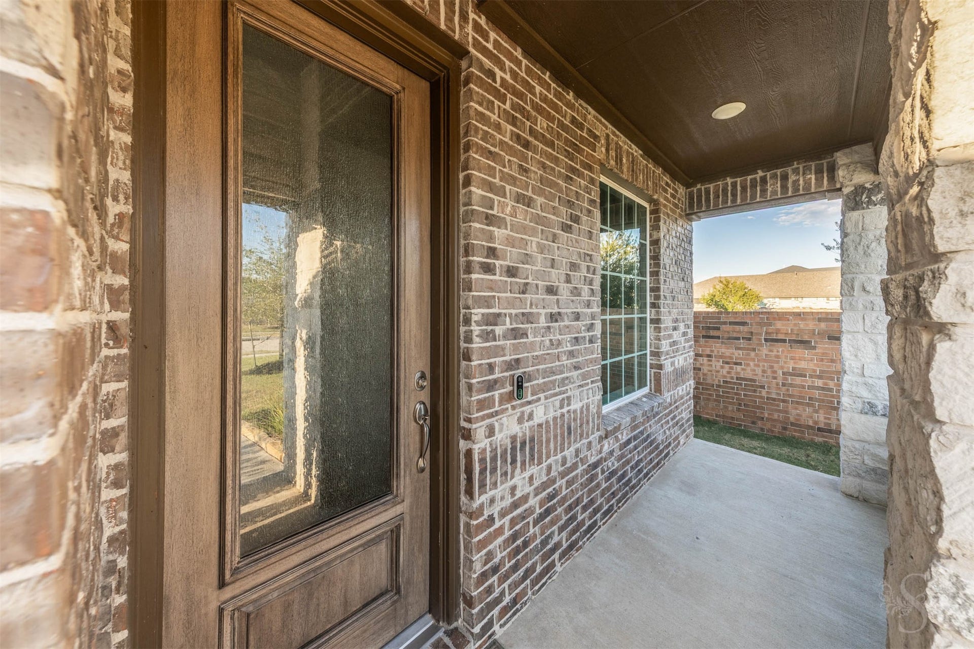 20922 Maudine Drive, Cypress, TX 77433 Rich brickwork and stone accents frame the sheltered front porch, creating a beautiful welcome to this stylish Taylor Morrison home. A wood front door with textured glass offers an elegant introduction to the inviting spaces within.
