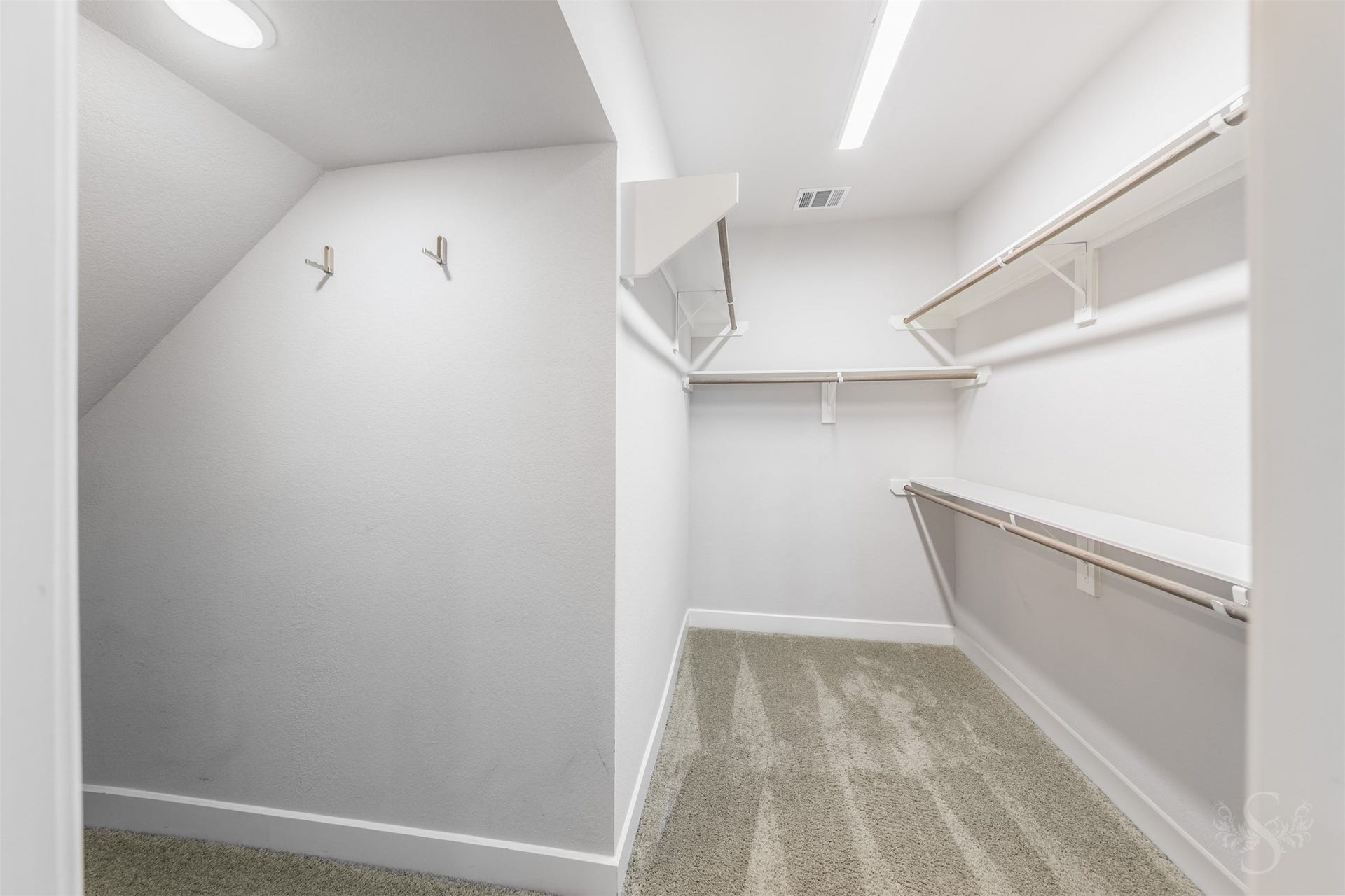 20922 Maudine Drive, Cypress, TX 77433 The spacious primary closet offers multiple hanging rods and overhead shelving to keep your wardrobe organized. An additional nook provides space for shoes, luggage or seasonal storage.