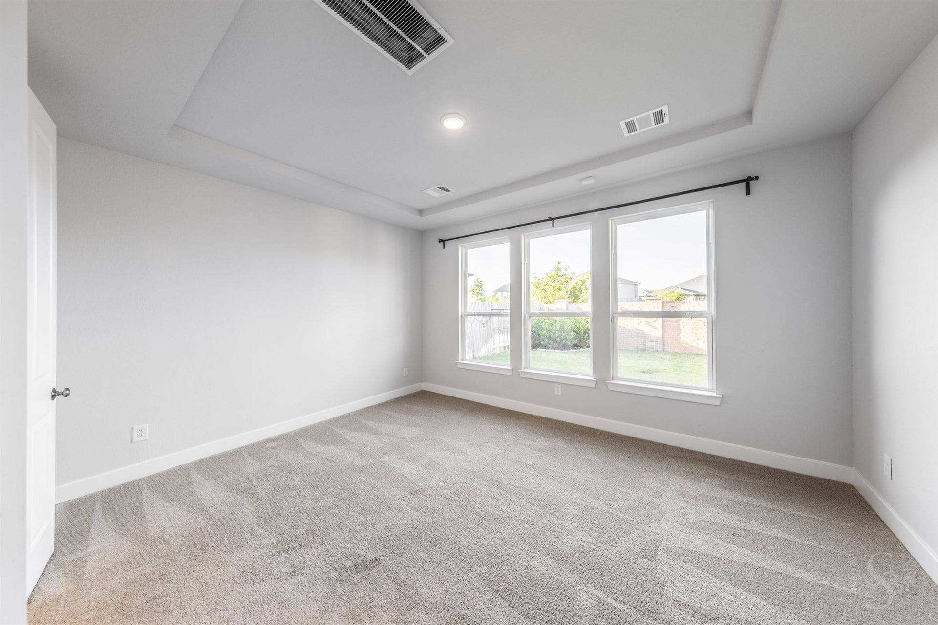 20922 Maudine Drive, Cypress, TX 77433 The spacious primary bedroom offers a peaceful retreat with an elegant tray ceiling and soft, neutral finishes. Three large windows overlook the back yard, creating a bright and inviting place to unwind.