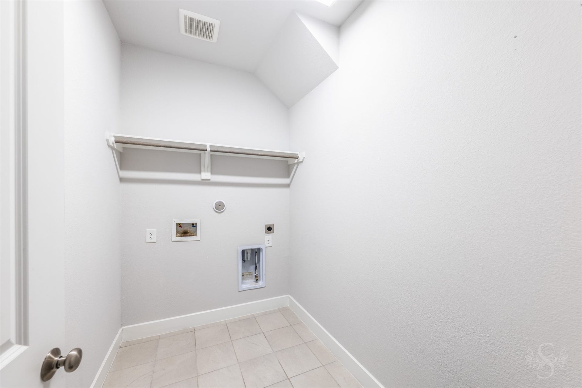 20922 Maudine Drive, Cypress, TX 77433 The laundry room features tile flooring and a convenient overhead shelf for storing everyday essentials. A hanging rod provides a handy spot to air-dry clothing or hang freshly pressed items.