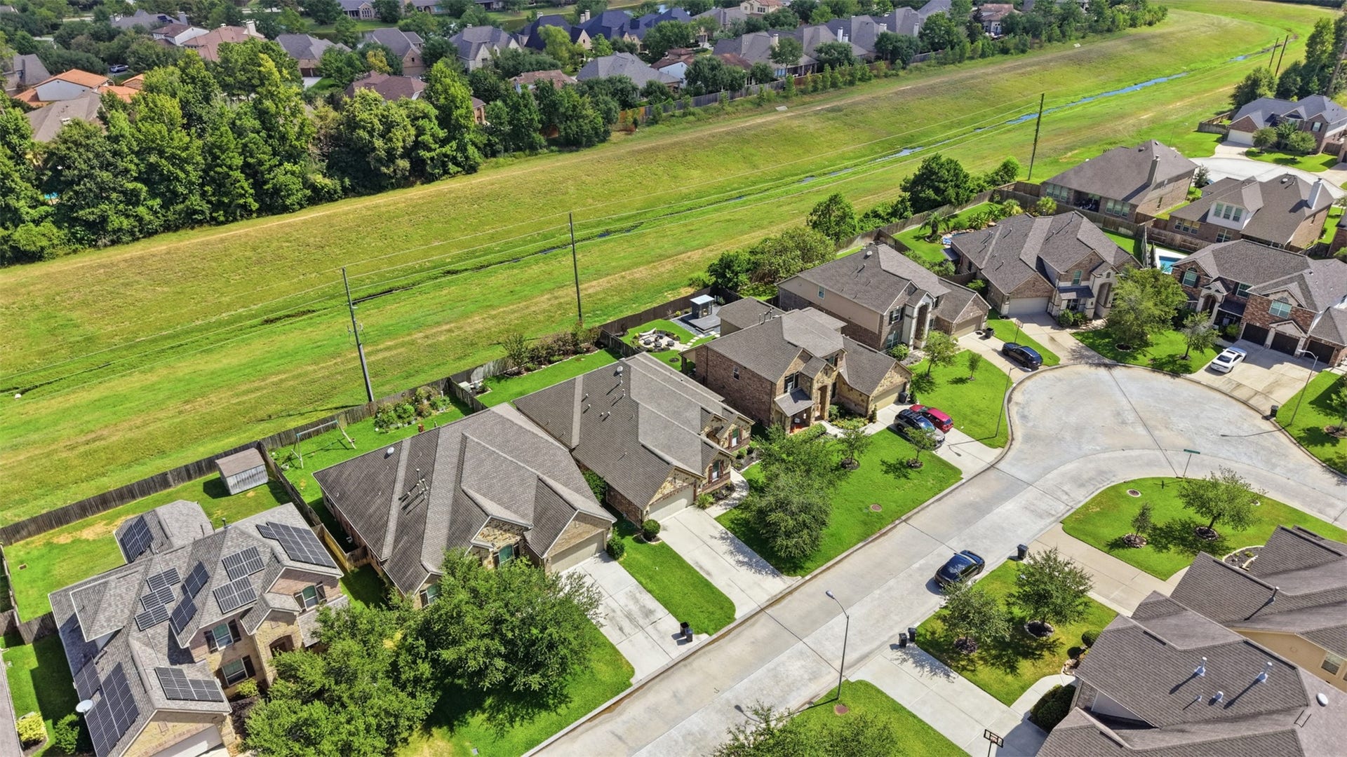 Aerial view showcasing the homes location within the community on a greenbelt lot.
