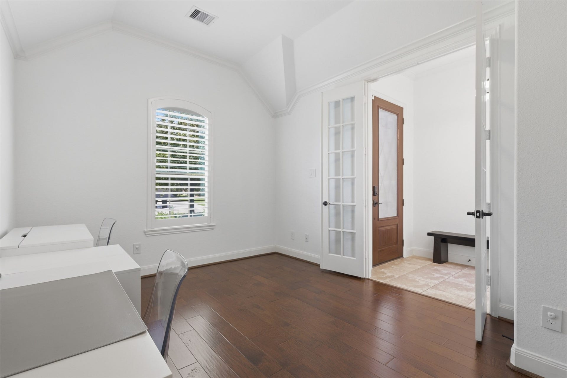 Additional view of the home office featuring beautiful wood vinyl flooring and French doors.