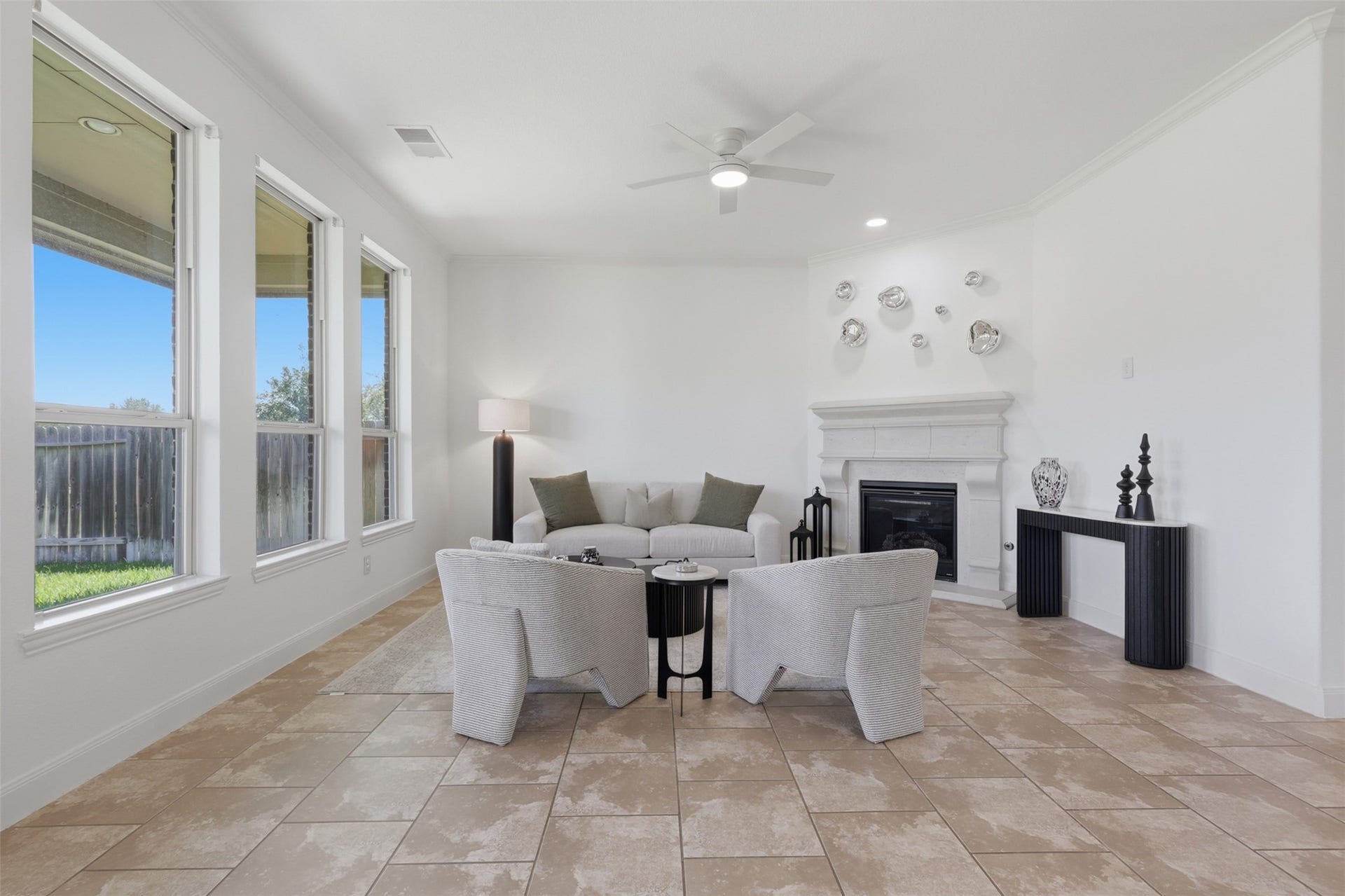 Spacious living room with an open layout, abundant natural light, and a cozy gas-log fireplace.