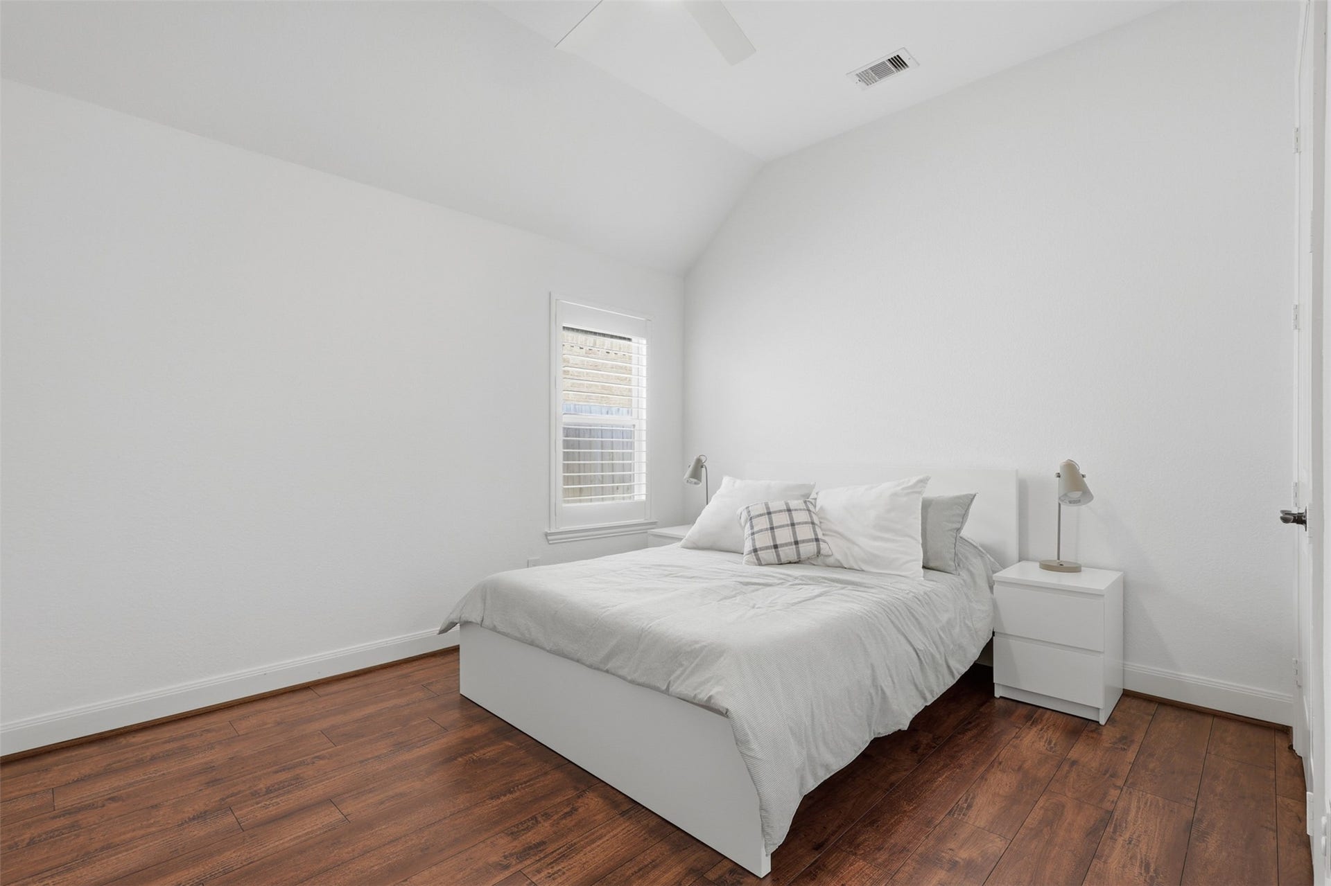 Additional bedroom offers a bright, comfortable retreat with wood vinyl flooring.